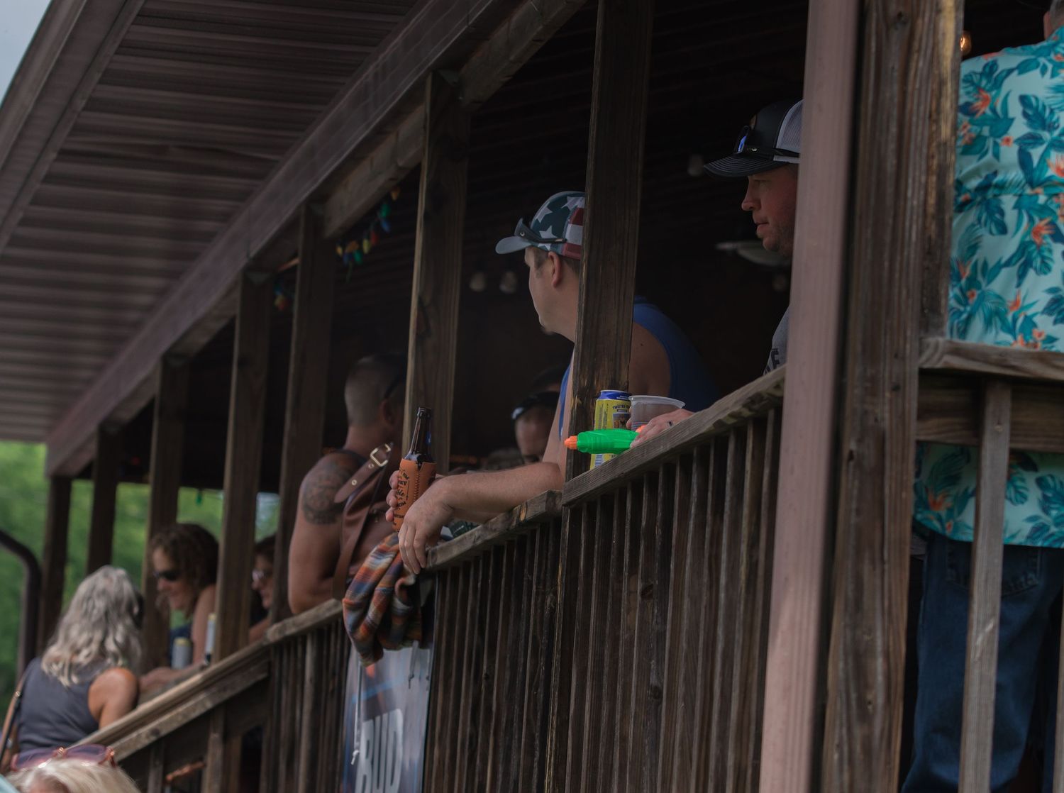 Spectators watching from a covered wooden deck or viewing platform.