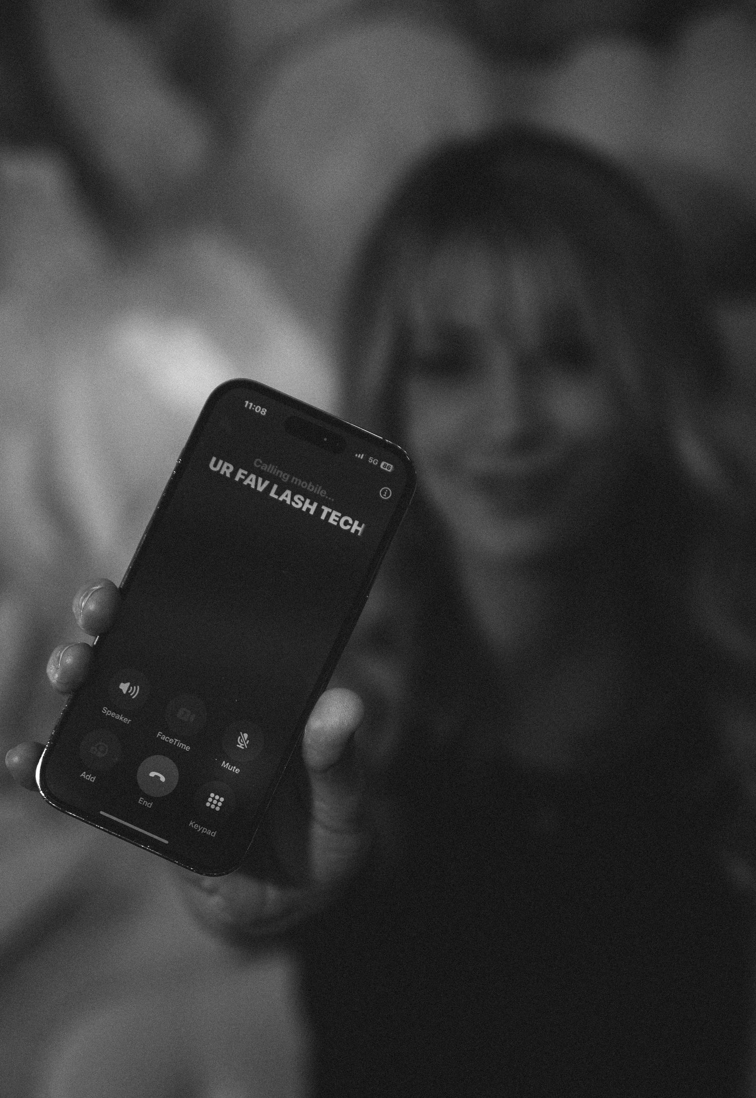 Close-up view of a Canon Tech wireless device shown in soft black and white focus.