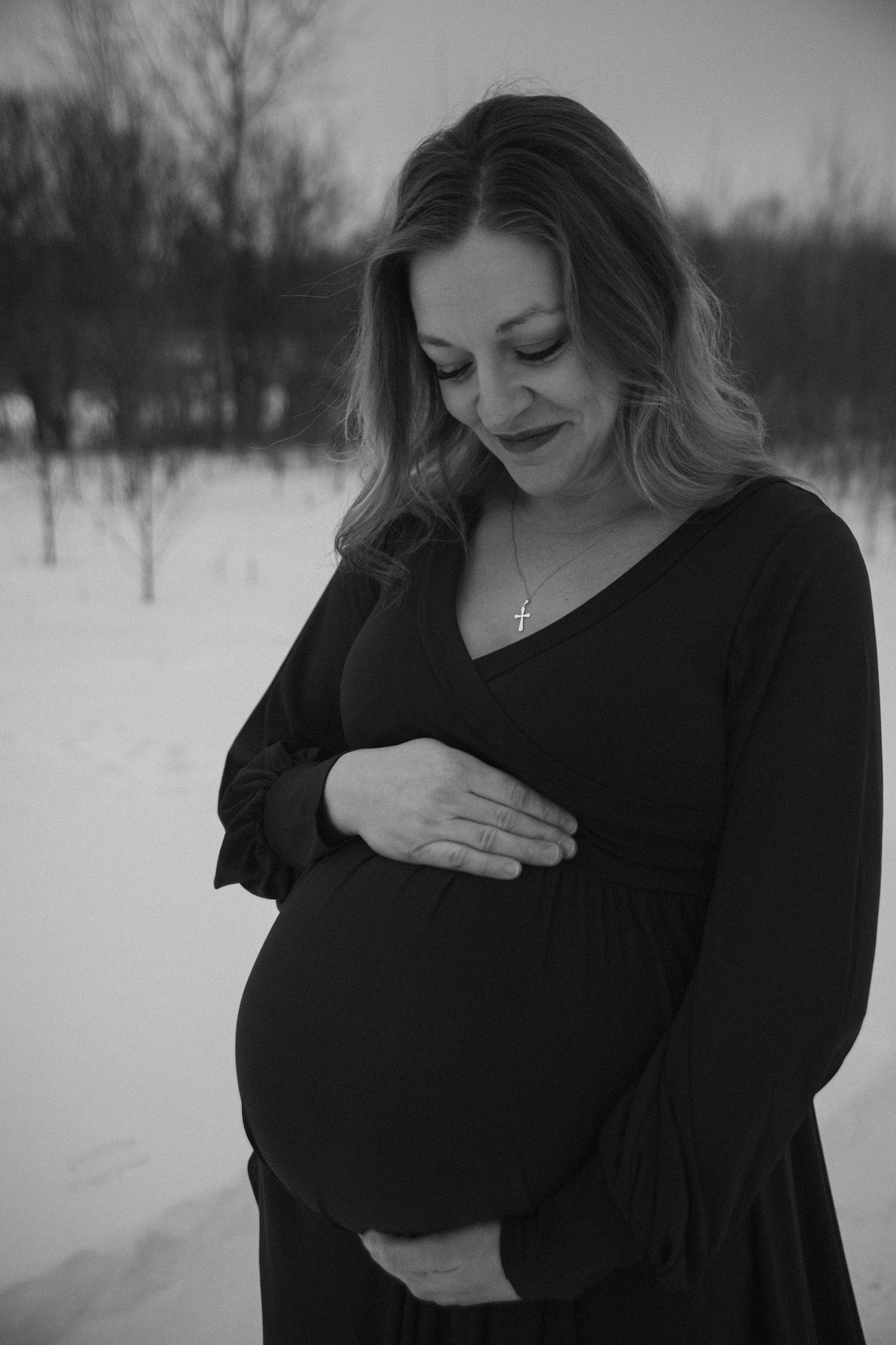 Black and white portrait series showing intimate emotional moments against a snowy winter backdrop.
