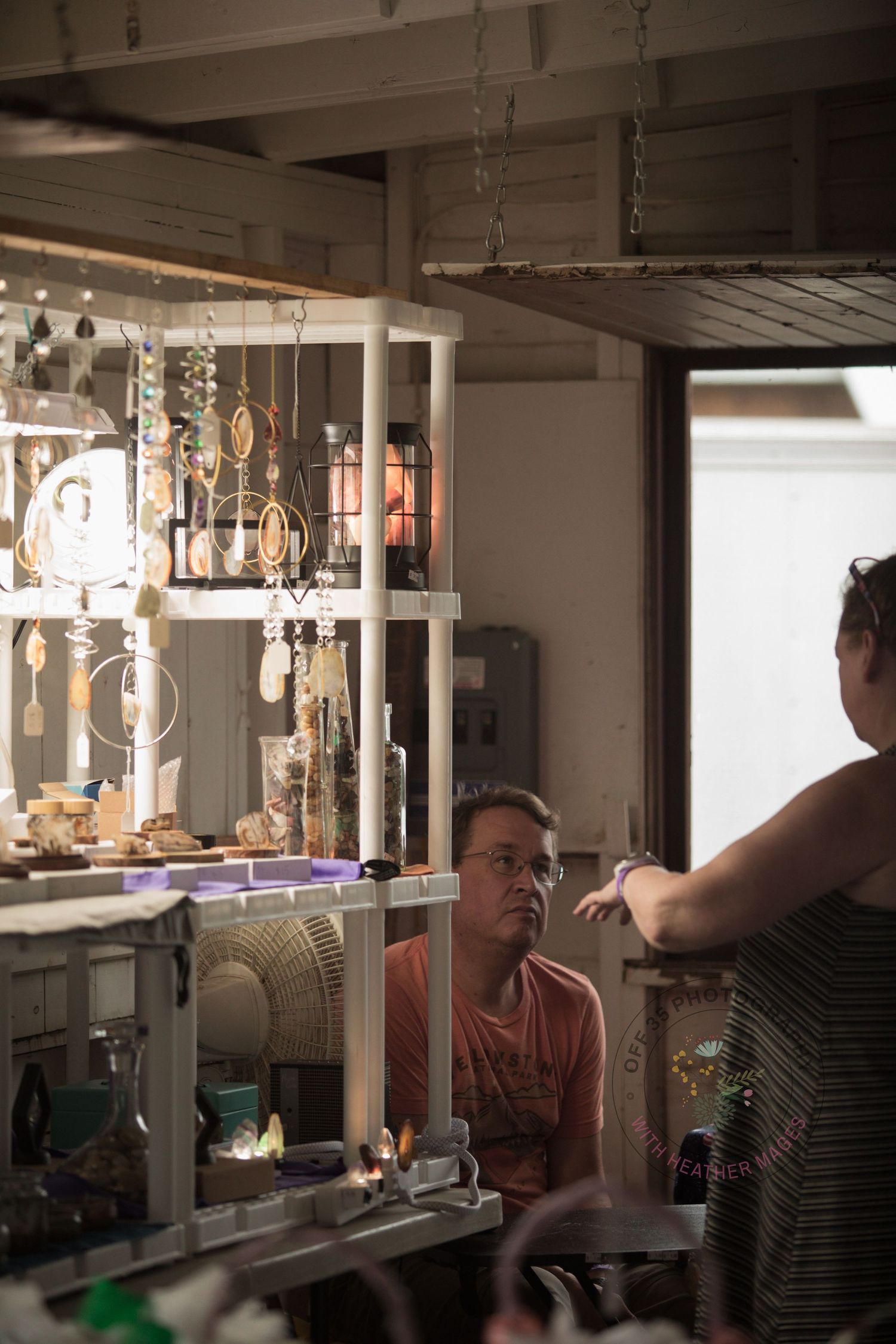 Interior workshop space with hanging lights and tools visible along workbenches and walls.