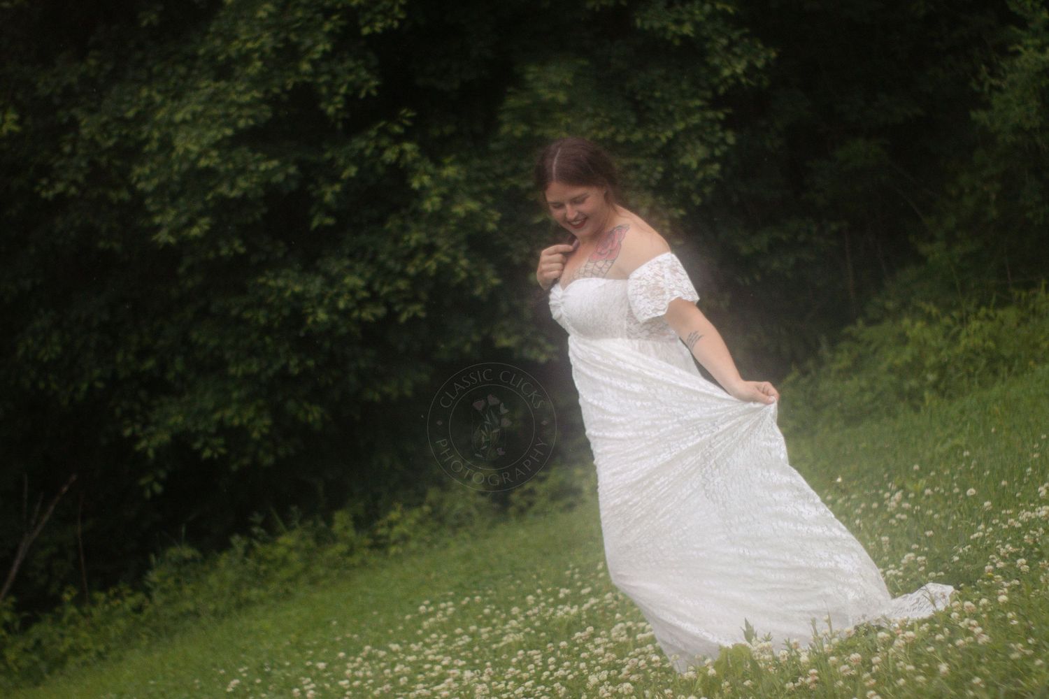 A figure in a flowing white dress twirls gracefully in a lush green meadow filled with wildflowers.