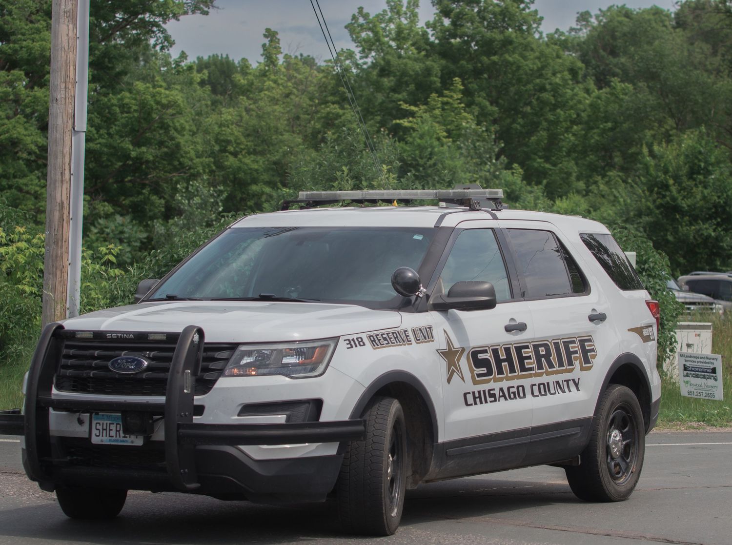 A white Burleigh County Sheriff patrol SUV vehicle parked on a rural road.