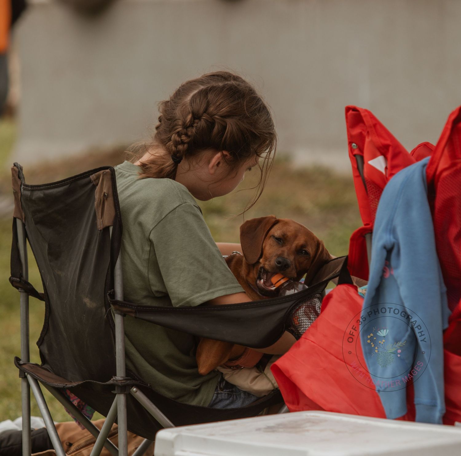 A relaxed outdoor scene with camping chairs and colorful blankets at a community event.