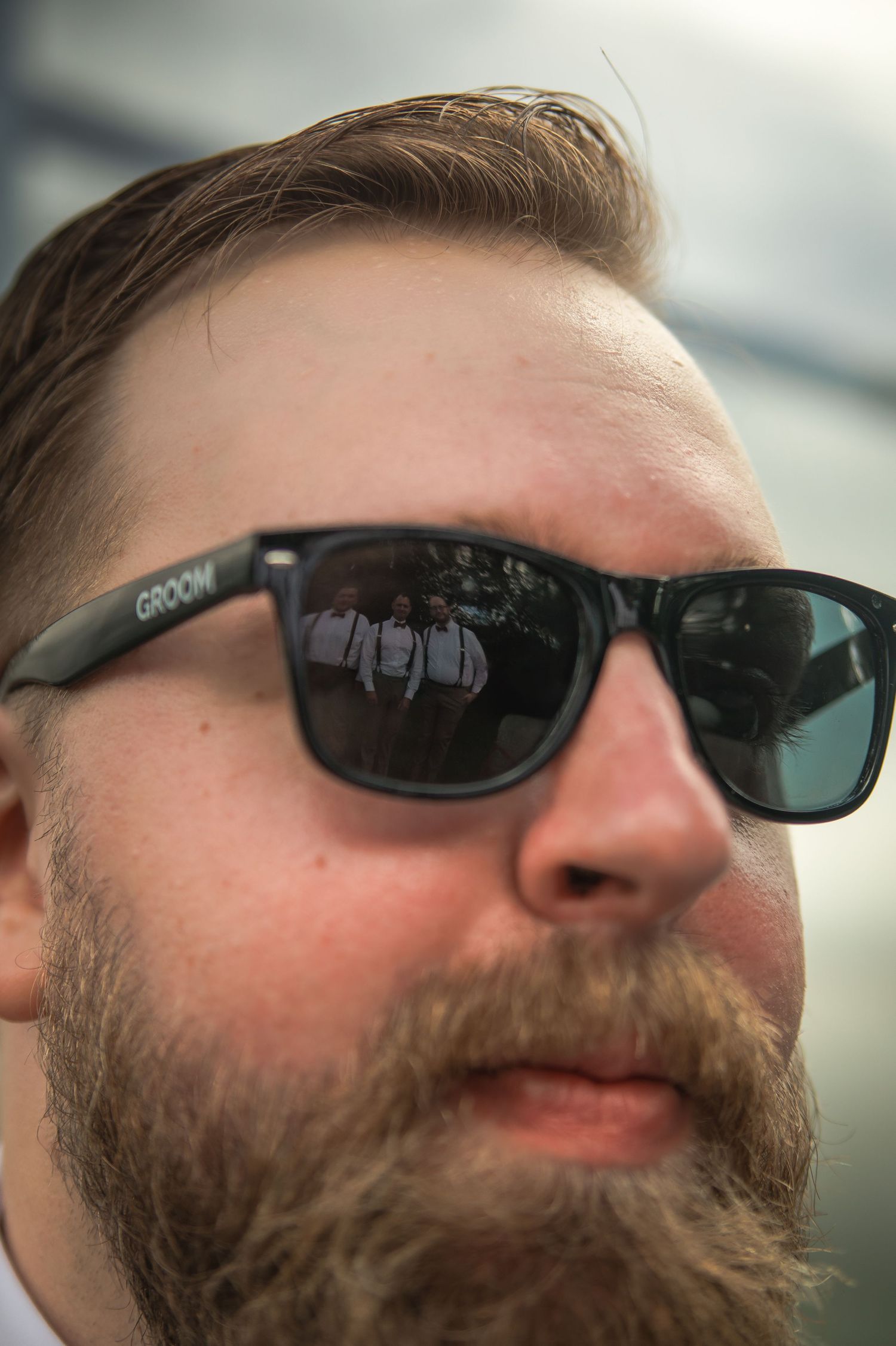Close-up series of a bearded man wearing dark sunglasses shown from different angles.