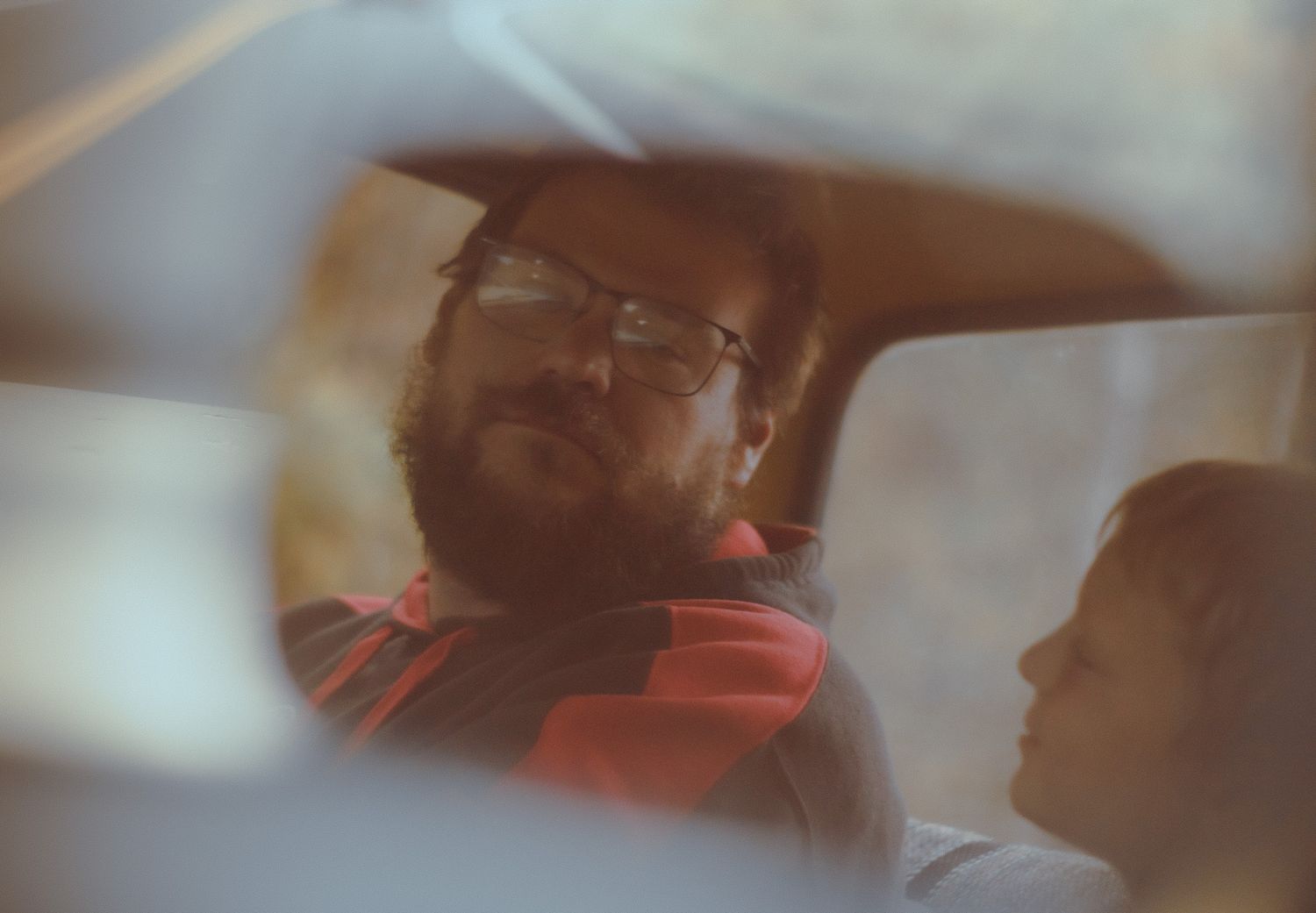 A sequence of blurry images showing someone in red headphones listening to music in warm lighting.