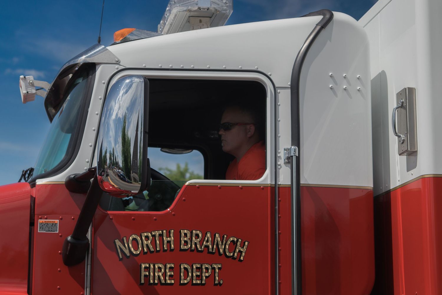 Close-up view of North Branch Fire Department emergency vehicle markings in red and white.