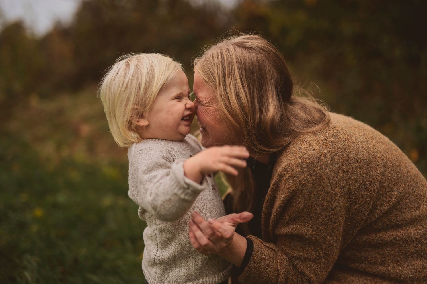 Intimate moment shared between two people in warm autumn lighting outdoors.