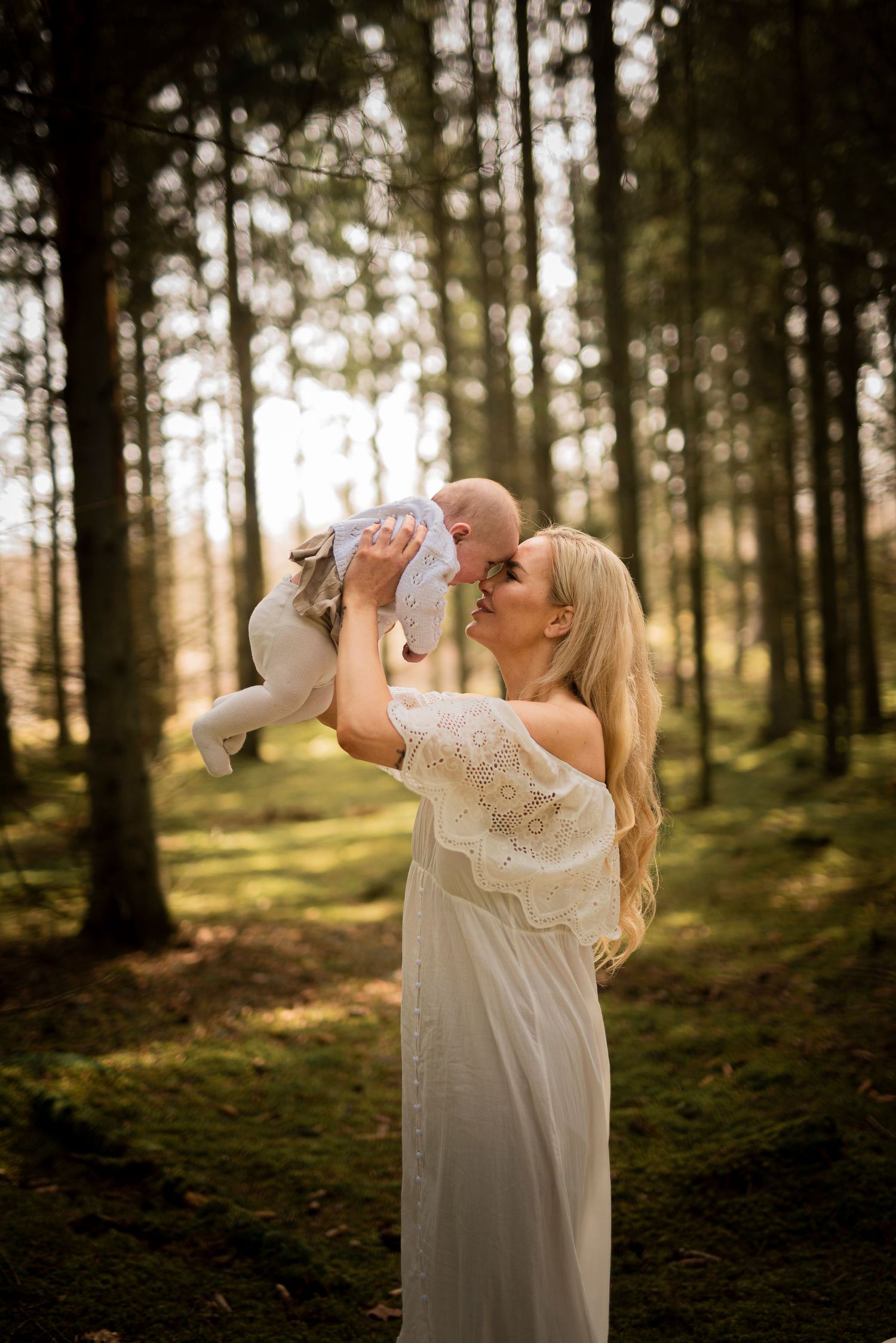 A joyful moment photographed in a sunlit forest with dreamy atmosphere.
