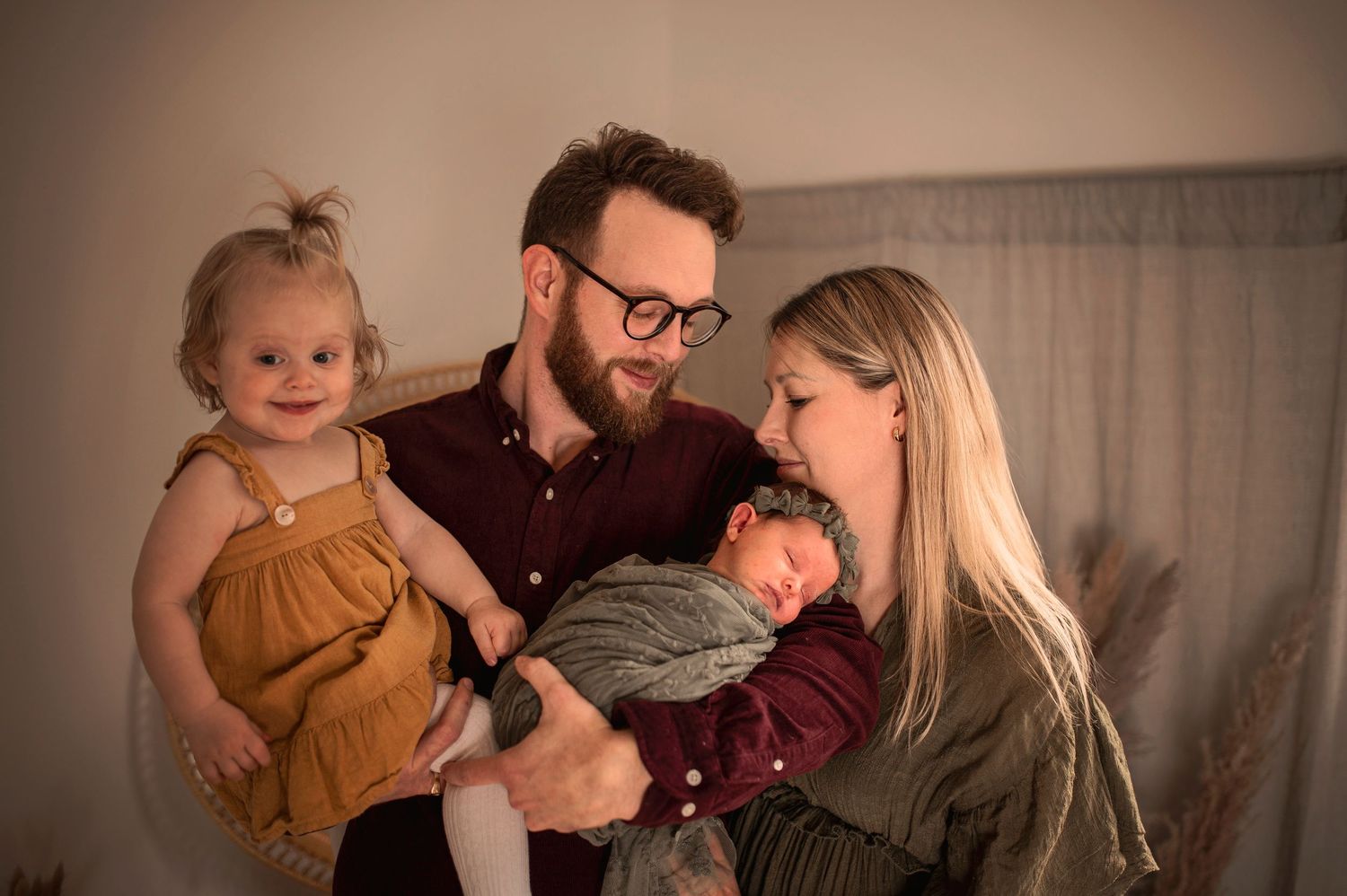 A series of candid family photos showing tender moments between parents and children in warm, cozy indoor settings.