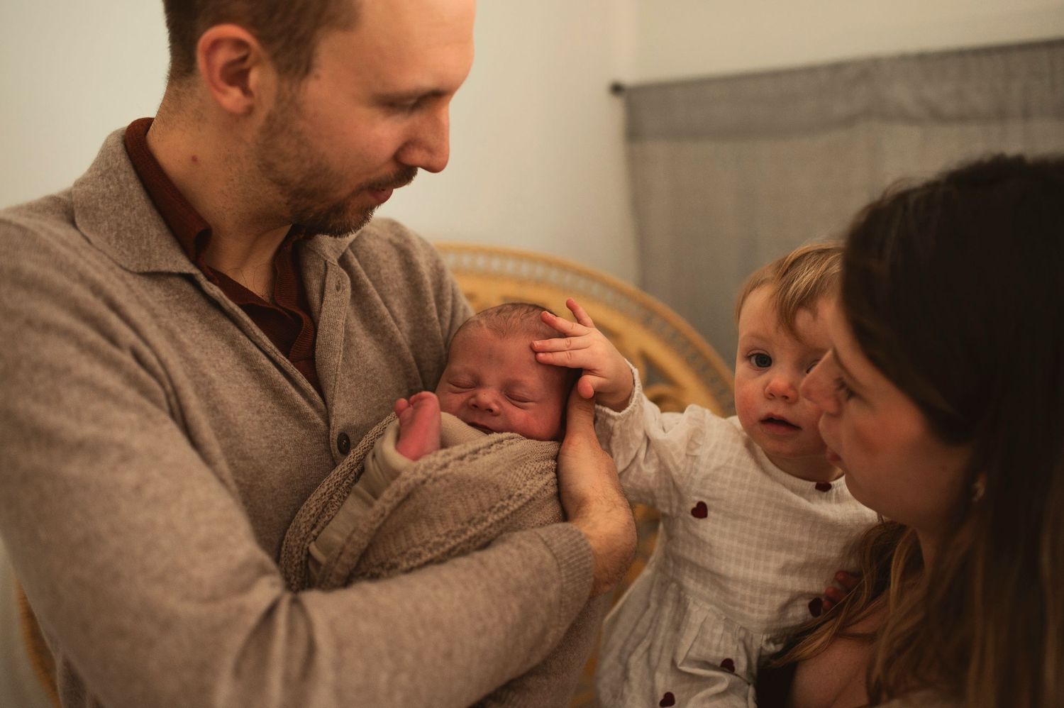 Warm family scene with parents and children sharing emotional moment together.