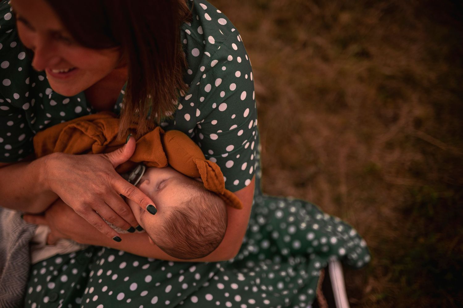 Intimate moment captured during sunset with polka dot dress visible.