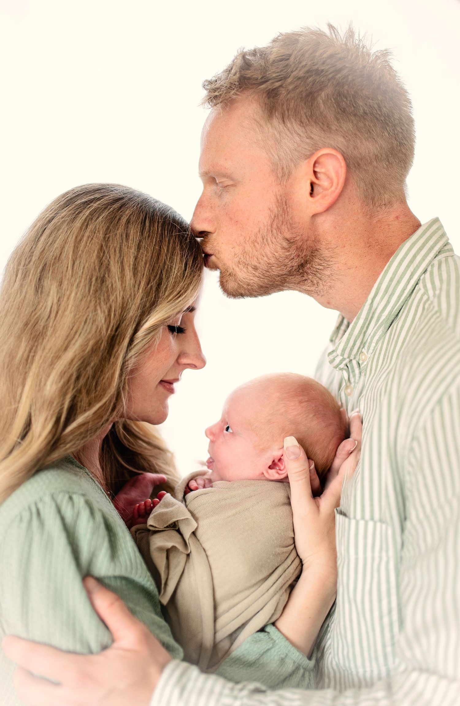 A series of intimate photos showing a couple in tender embraces wearing soft mint green and beige clothing.