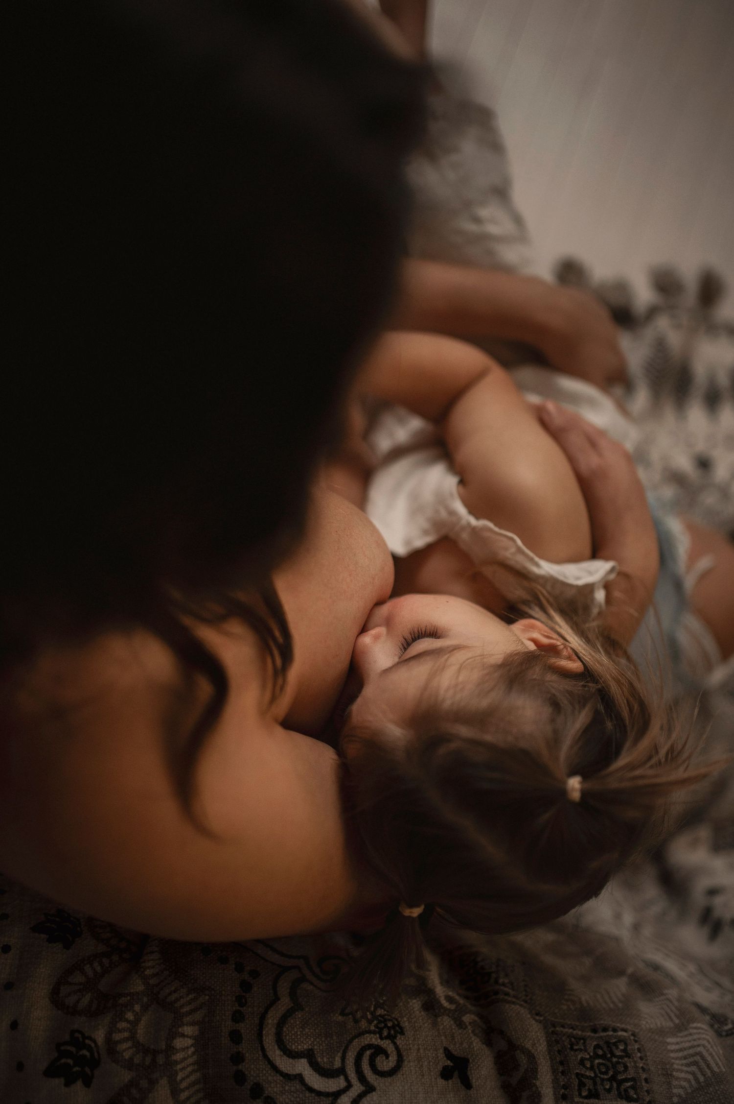 Overhead view of tender nurturing moment in soft lighting.