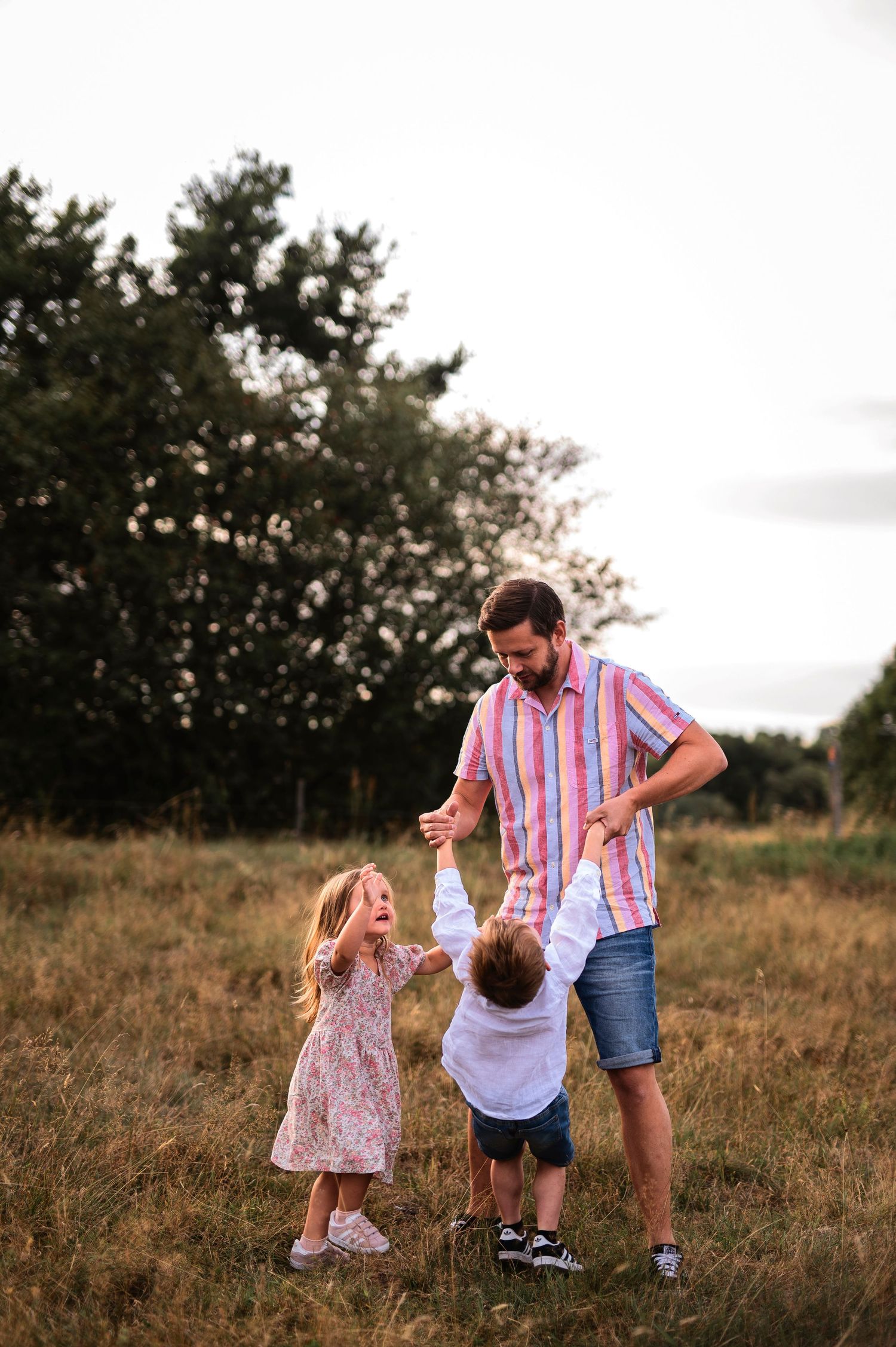 Playful moment captured in a meadow during golden hour.
