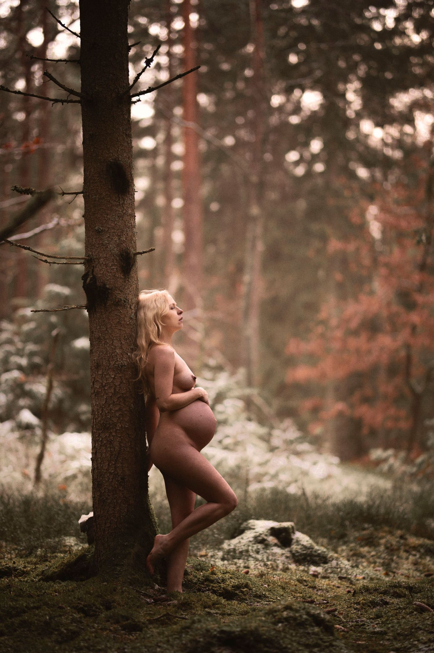Vacker gravid kvinna på gravidfotografering hos Lovestories By Sara. Nakenfoto i skogen.