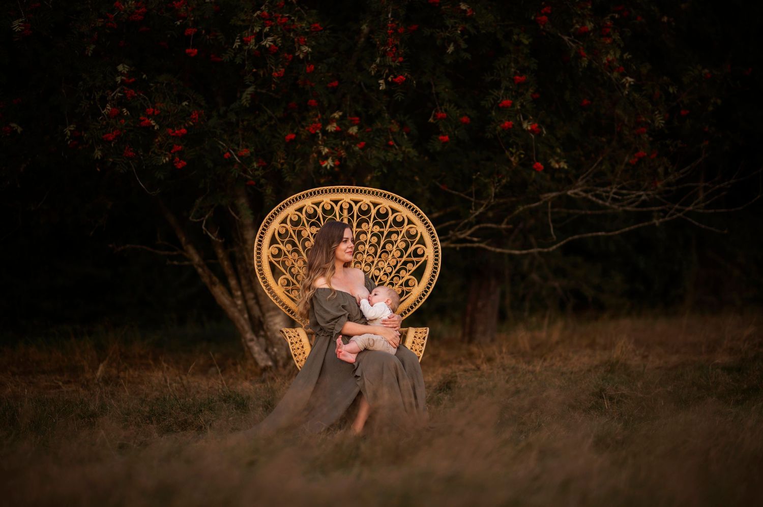 An illuminated vintage peacock chair creates a magical setting at twilight.