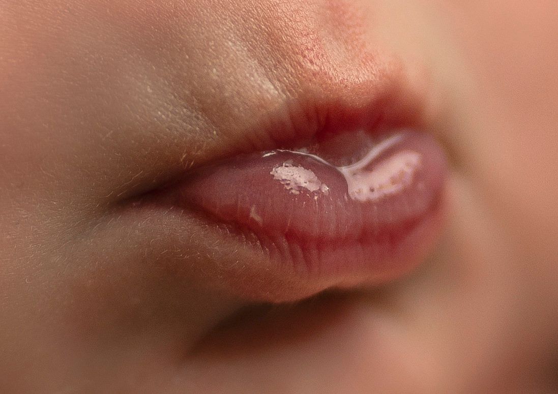 Extreme close-up macro shot of baby's lips and mouth.
