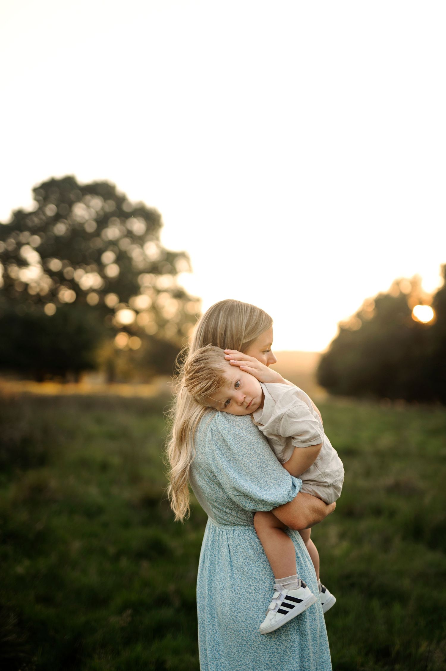 Tender embrace captured during golden hour in a serene outdoor setting.