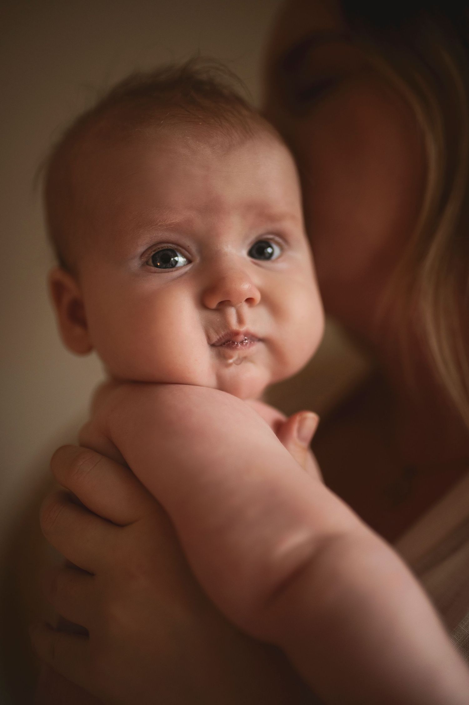 Close up portrait of alert baby with bright eyes and chubby cheeks.