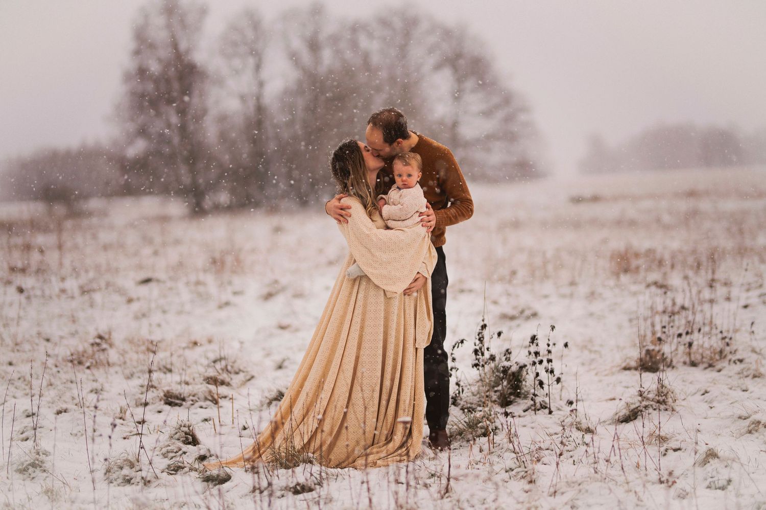Romantic winter portrait of a couple in a snow-covered field.