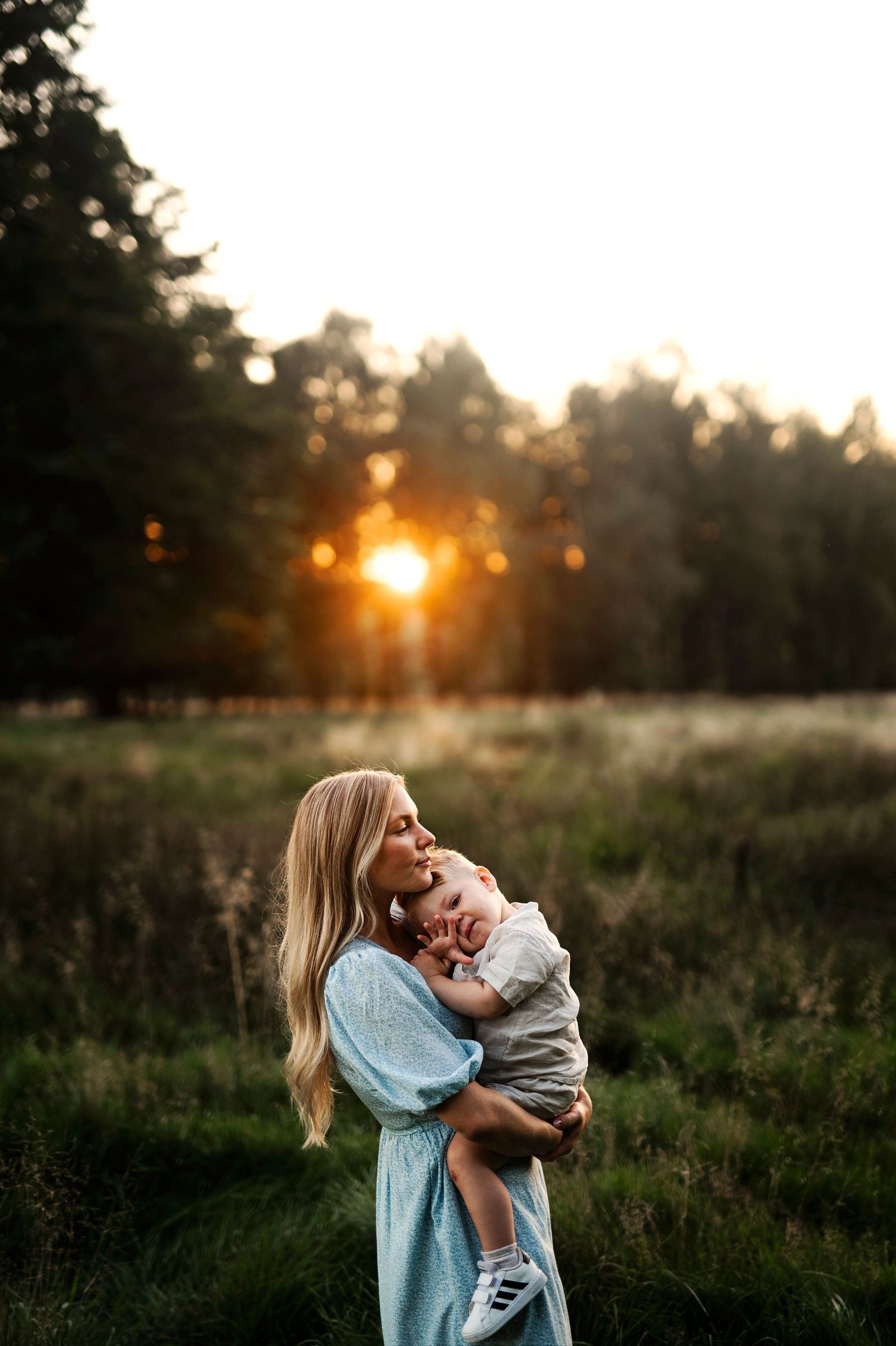 A joyful moment shared in a sunlit field during golden hour.
