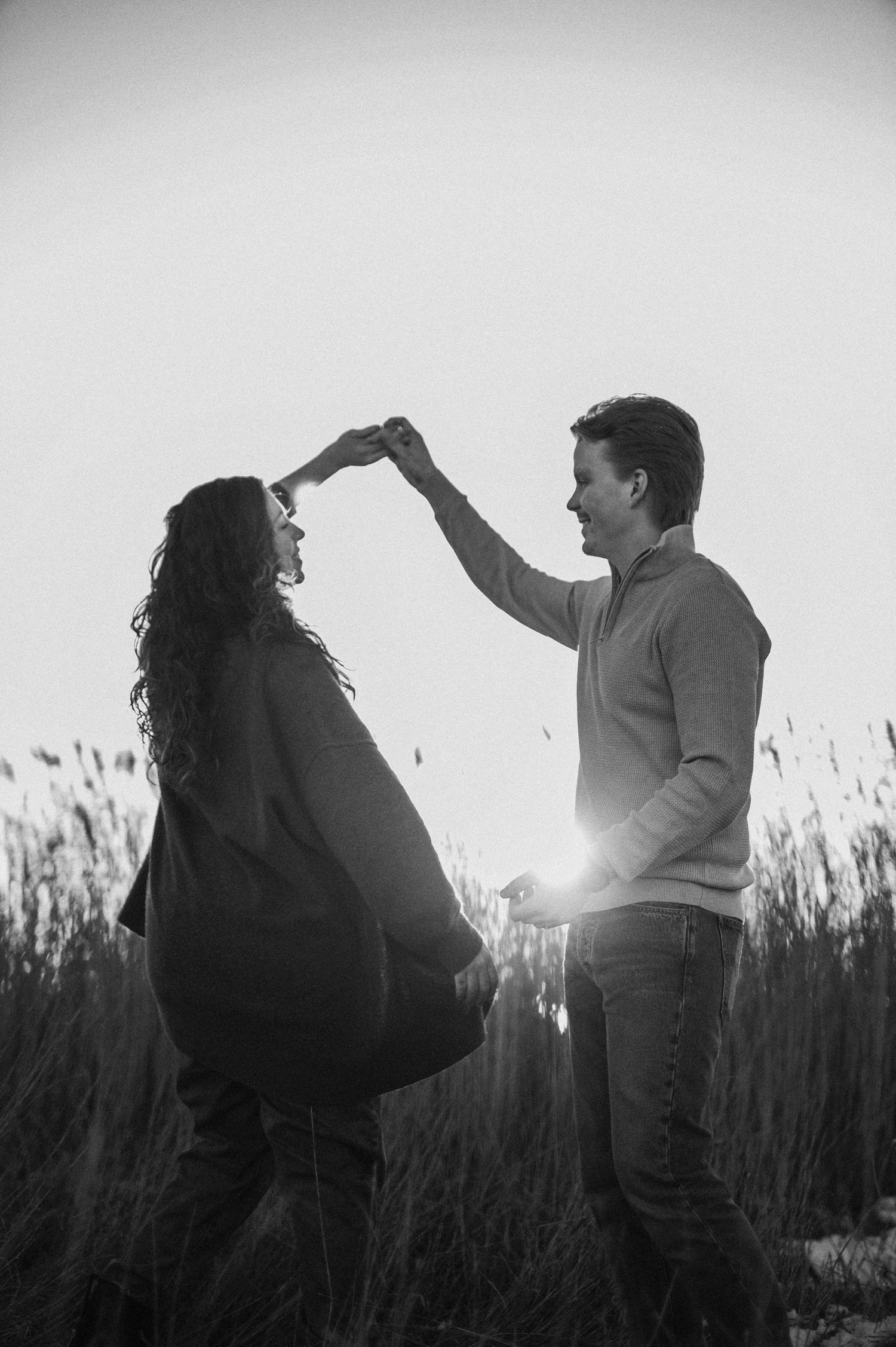 Black and white romantic maternity dance photo in natural setting.