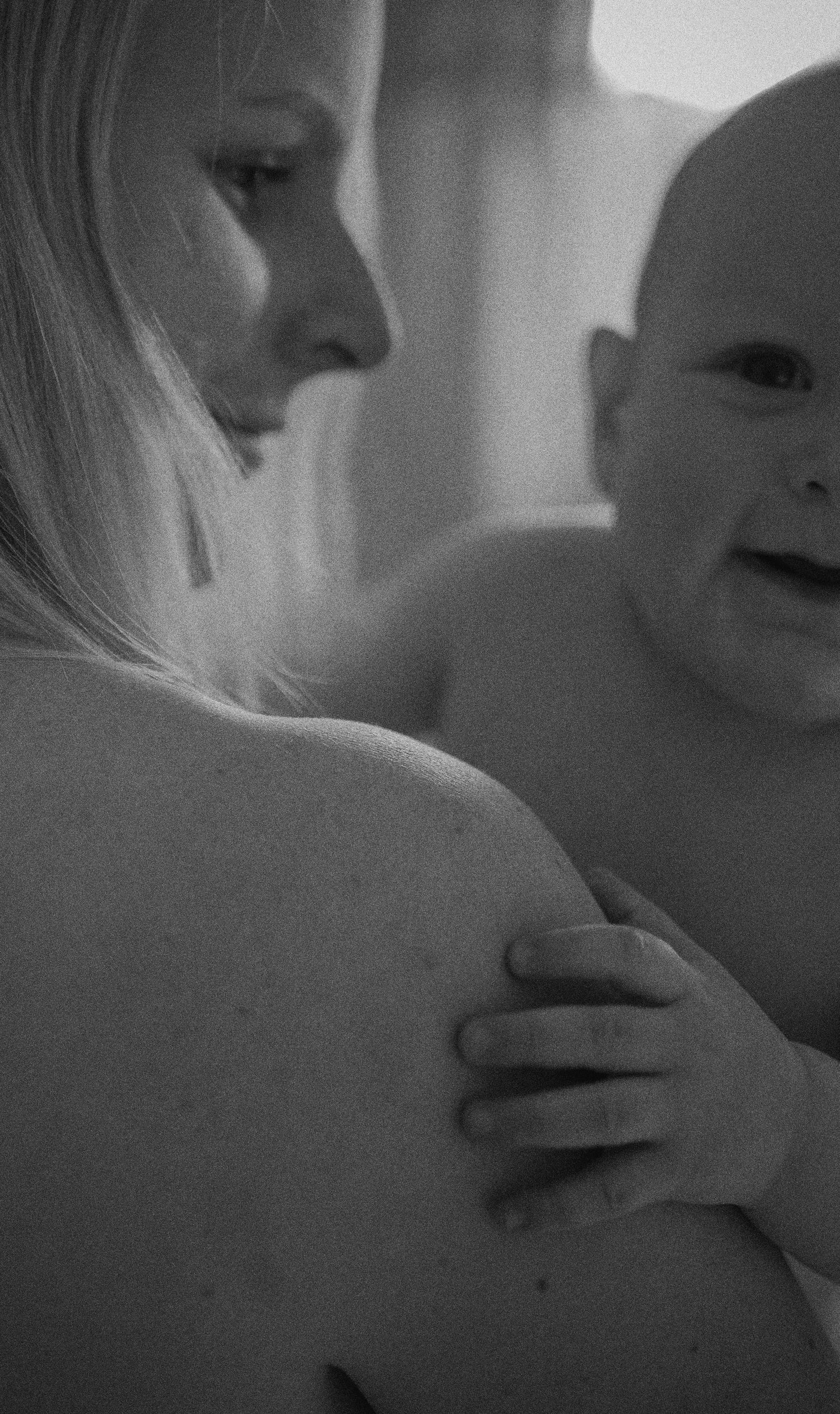 Intimate black and white portrait showing a tender parenting moment.