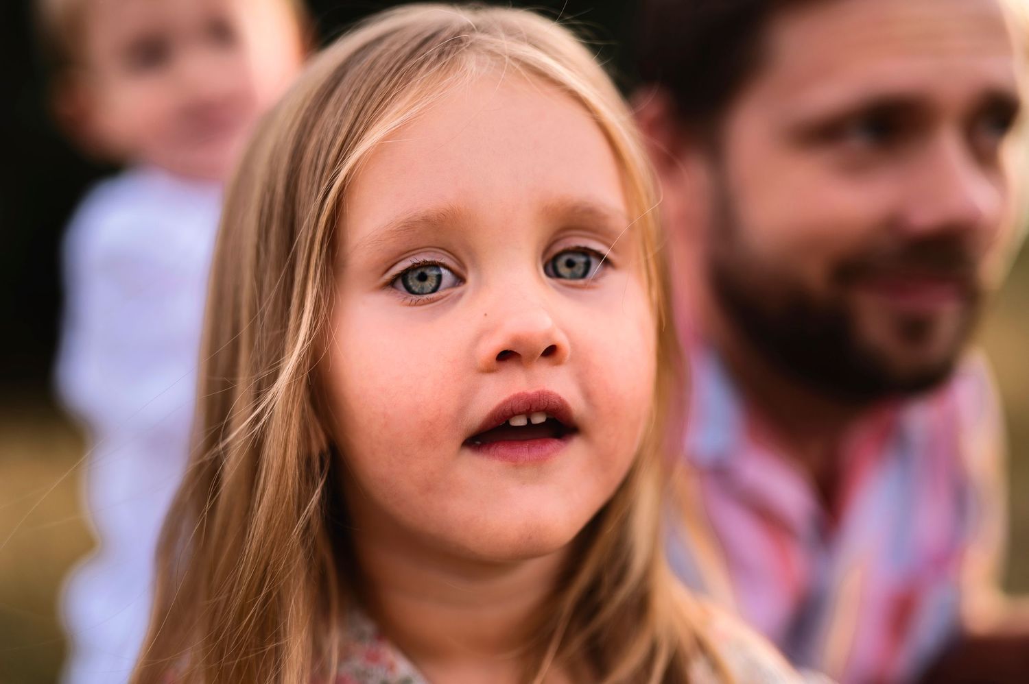 Close-up portrait in warm evening light outdoors.