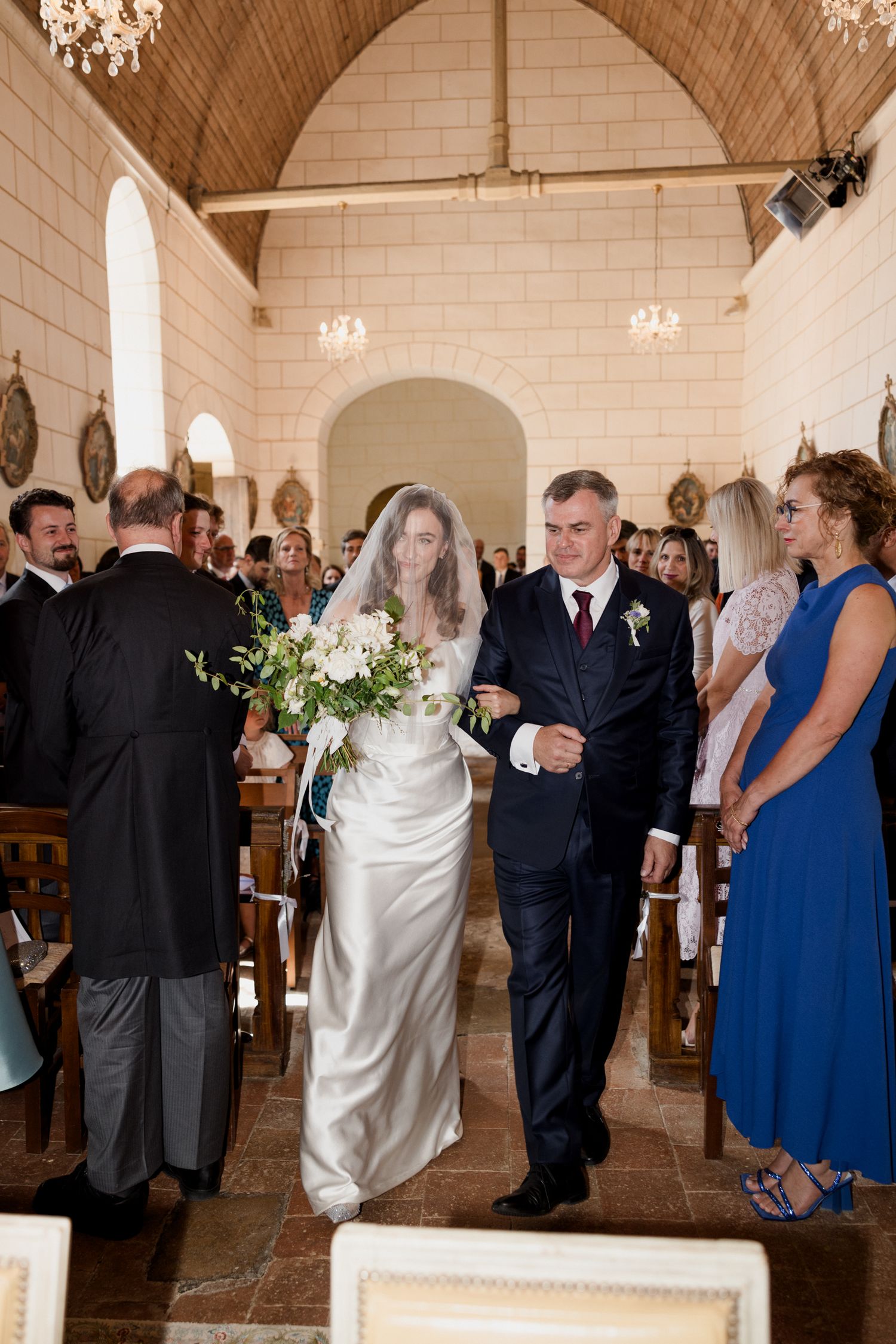 Wedding ceremony candid photos showing guests and a bride in white dress interacting in an elegant church venue.