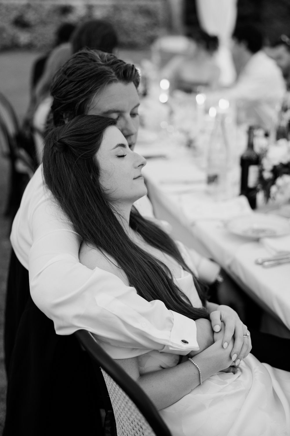 A sequence of black and white photos showing a person in white sitting at what appears to be a formal event.