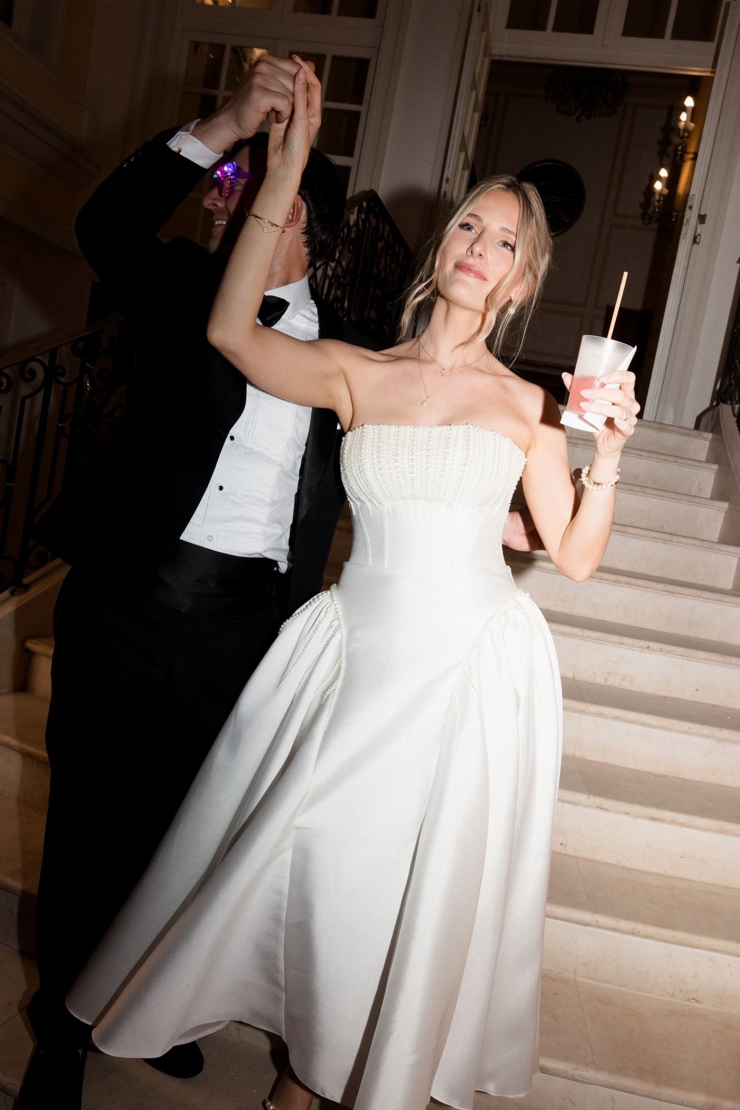 A series of black and white wedding photos capturing a couple dancing together in elegant formal wear. Editorial wedding photographer france
