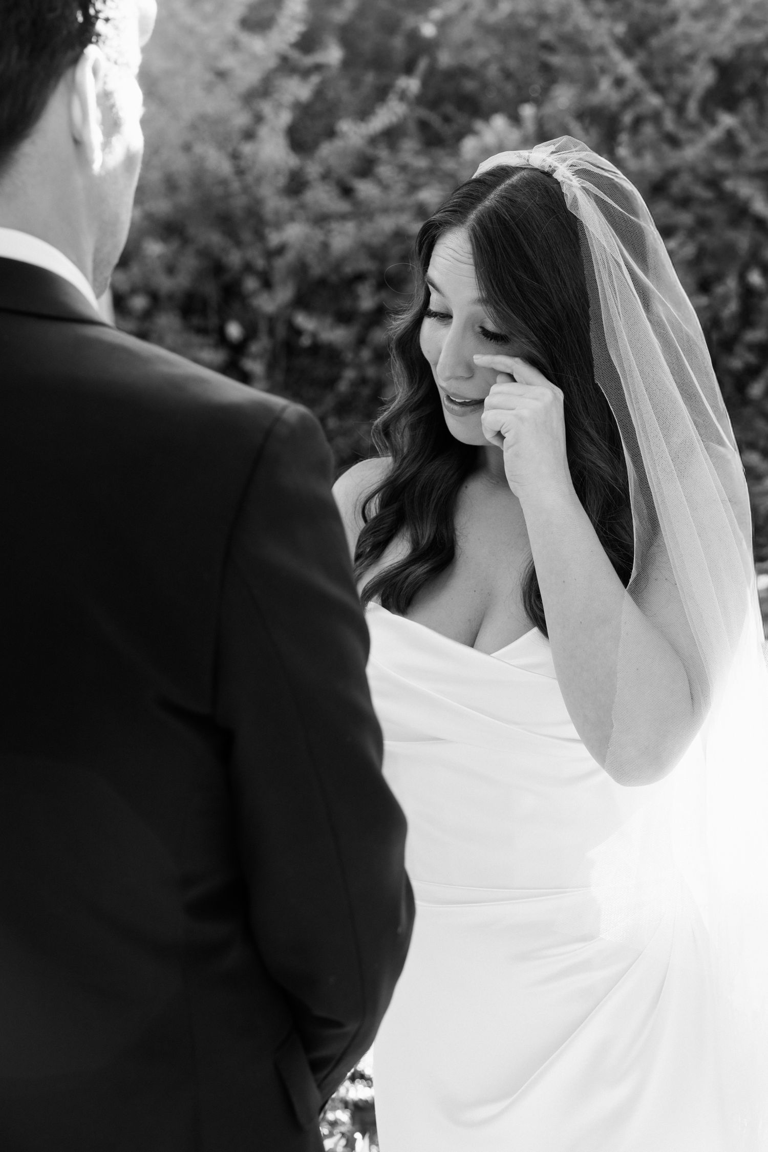A romantic black and white photo sequence showing a bride and groom sharing an intimate kiss during their wedding ceremony.