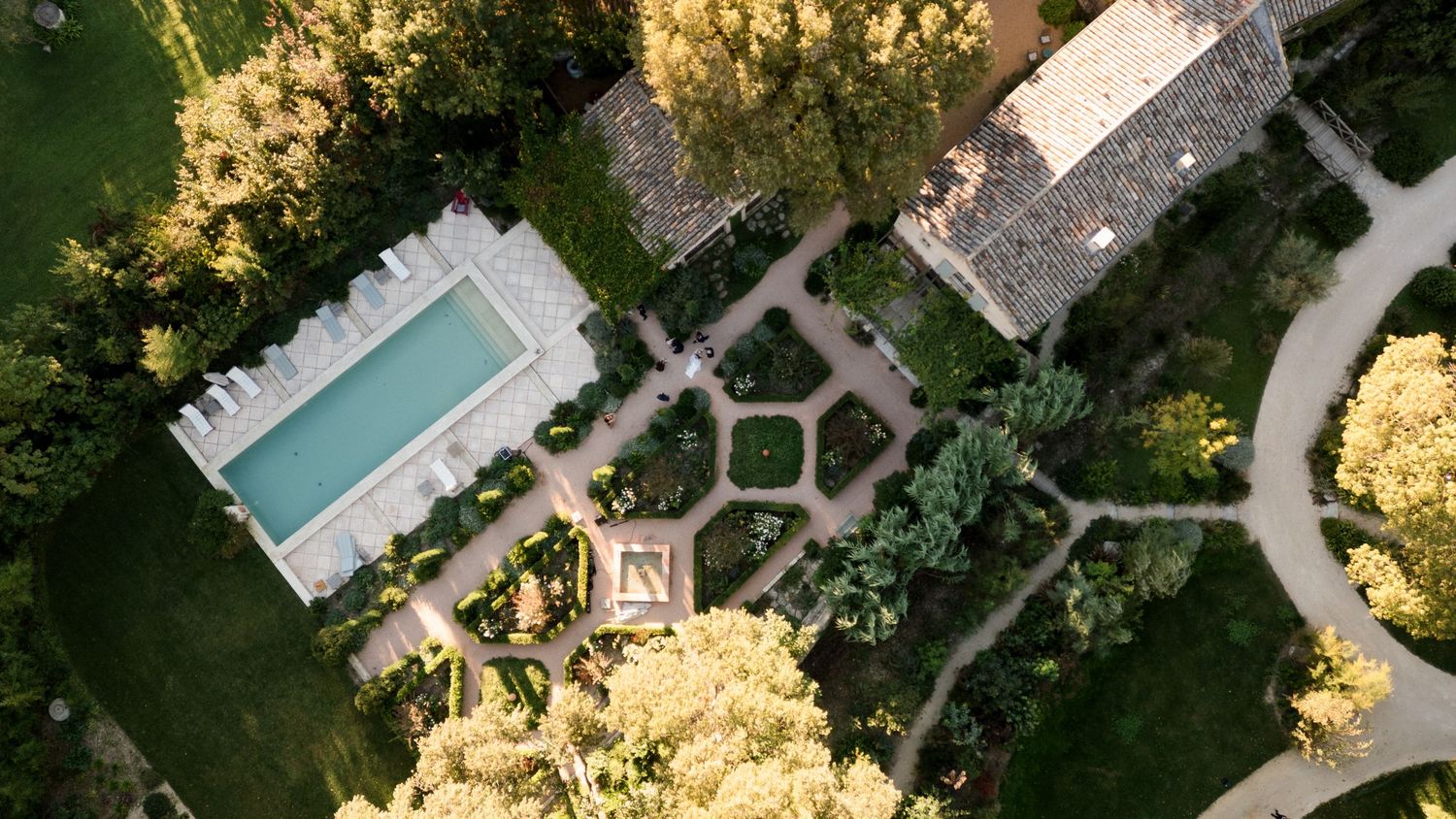 Aerial view of a luxury resort with swimming pools and landscaped gardens surrounded by tropical vegetation. provence wedding photographer