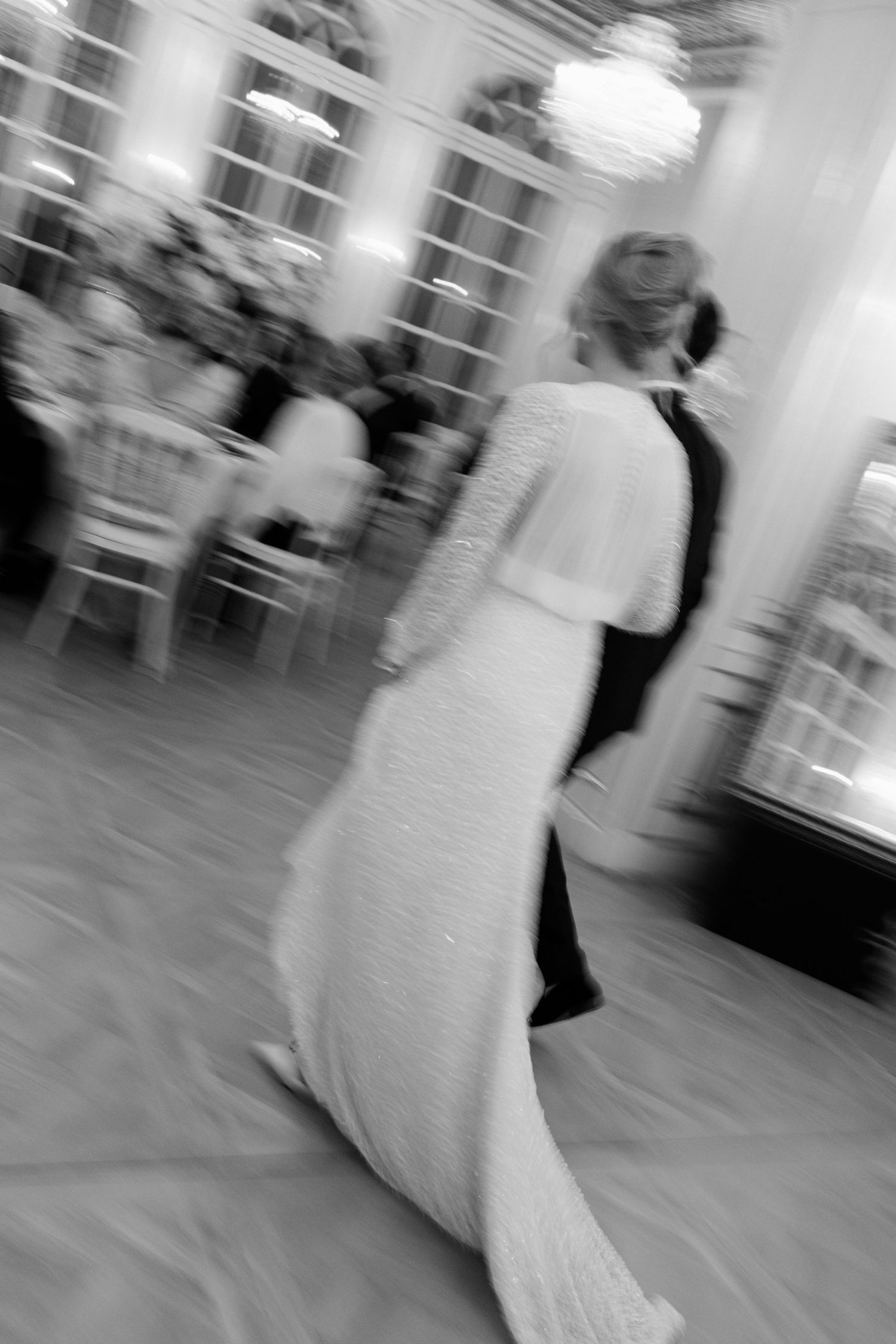A blurred black and white motion photograph of a couple dancing at an elegant event in formal attire. the lane photographer france