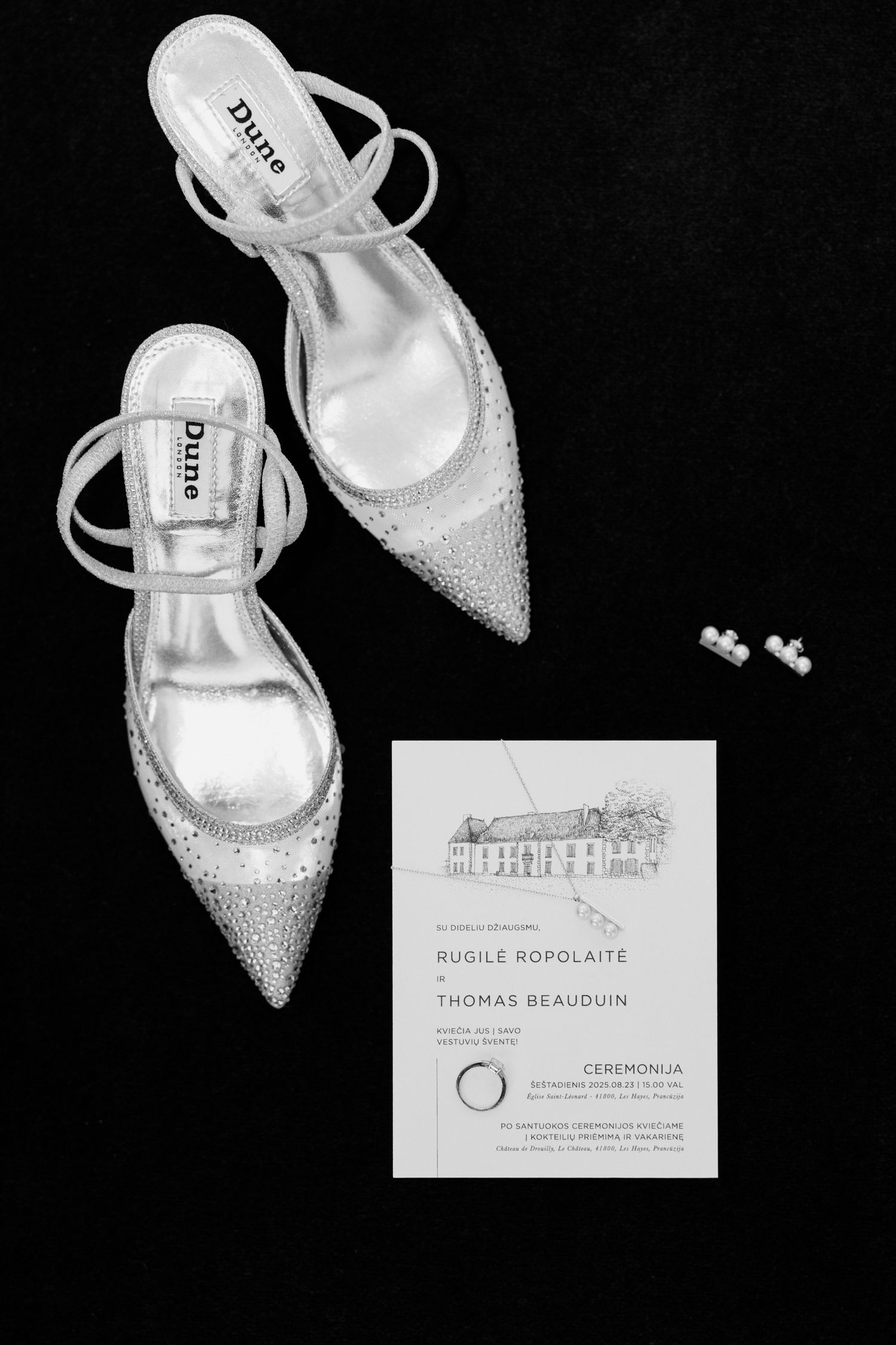 Elegant silver glitter slingback heels with pointed toes displayed alongside formal event invitation cards.