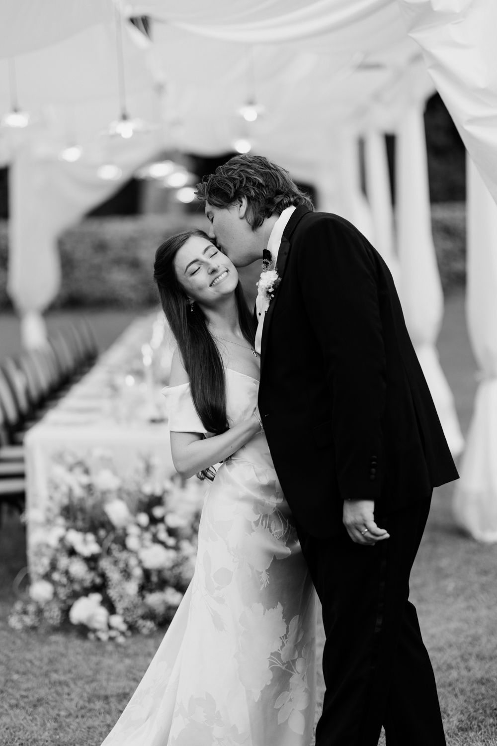 A bride and groom share a romantic dip pose while dancing outdoors at their wedding celebration. Château des 3 Fontaines wedding Provence
