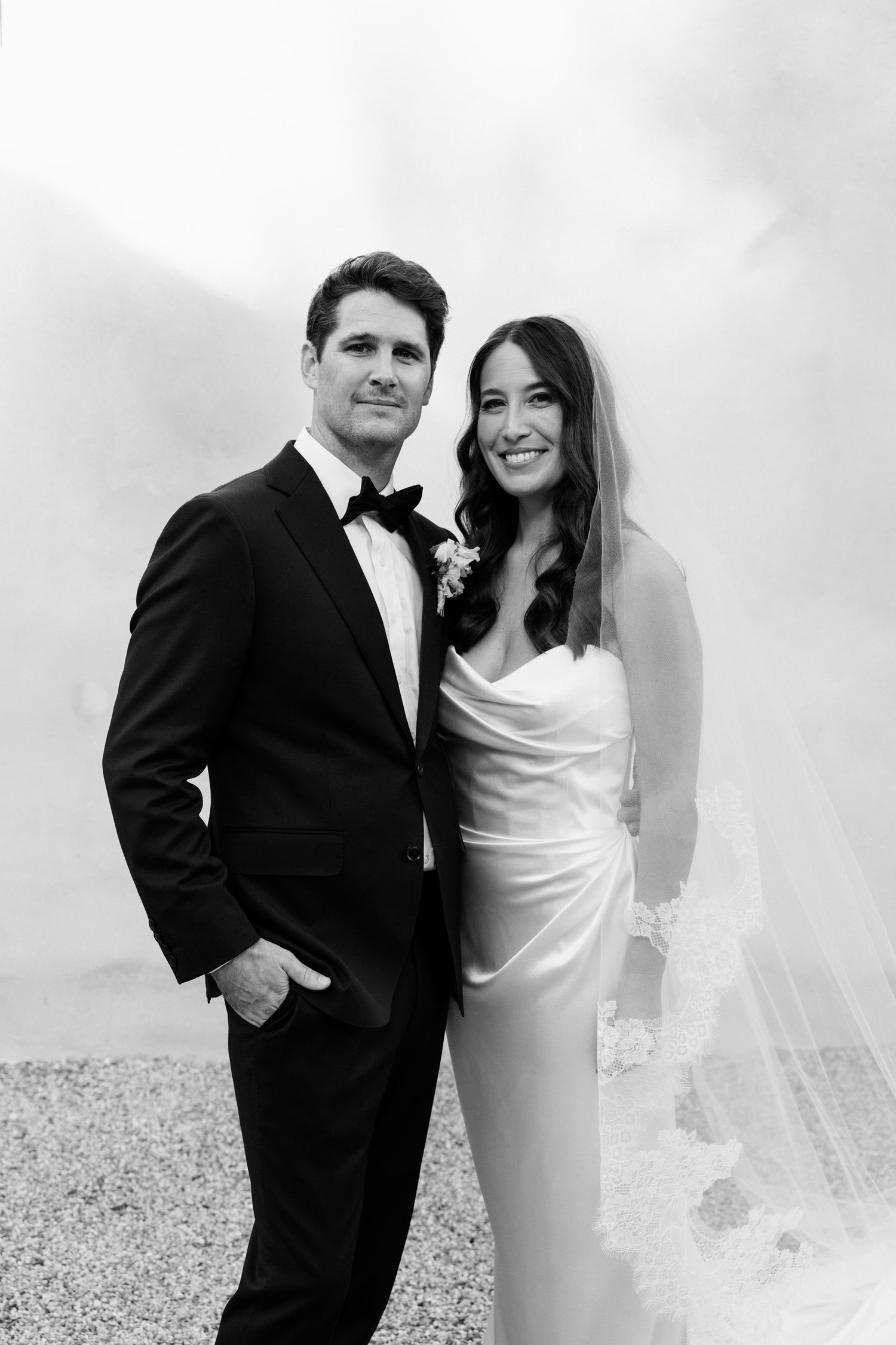 Black and white wedding photo series showing romantic poses of bride in white dress and groom in tuxedo. wedding photographer france