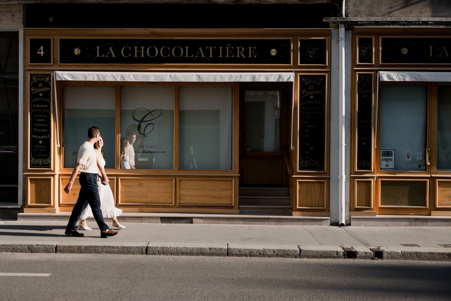 La Chocolaterie bakery storefront with illuminated signage and elegant vintage exterior design.
