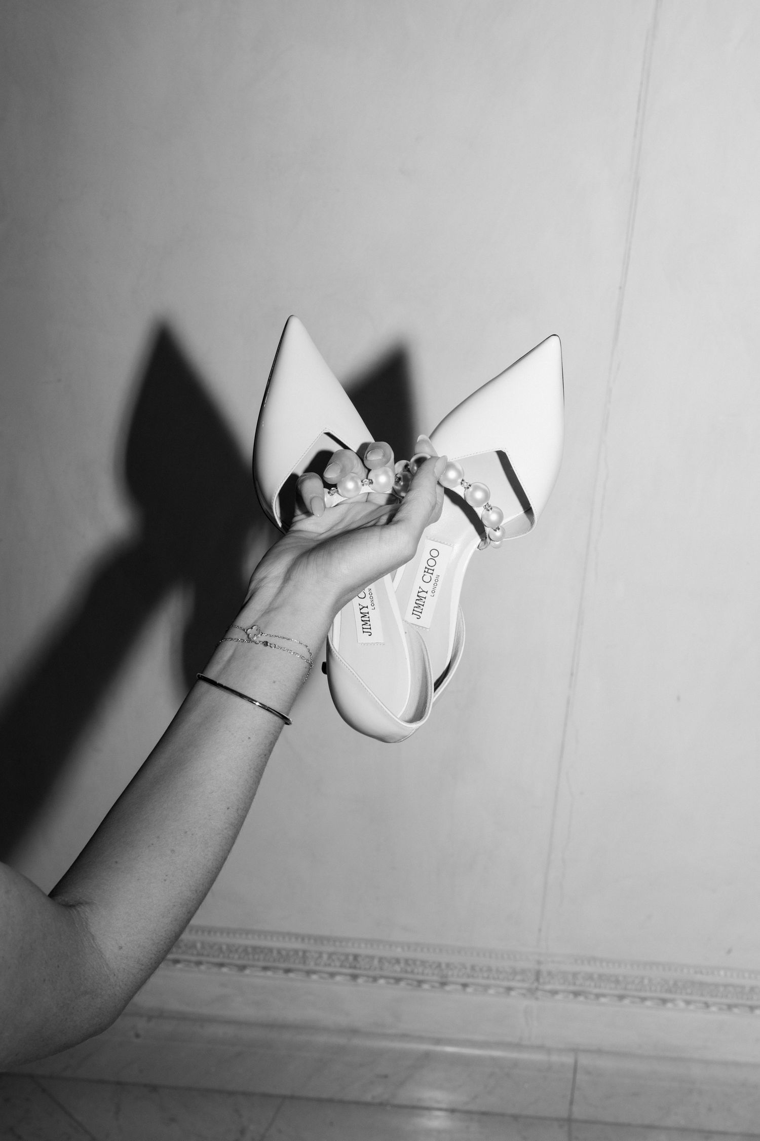 A sequence of black and white photos showing hands tearing paper in a minimalist artistic composition. Editorial wedding photographer france