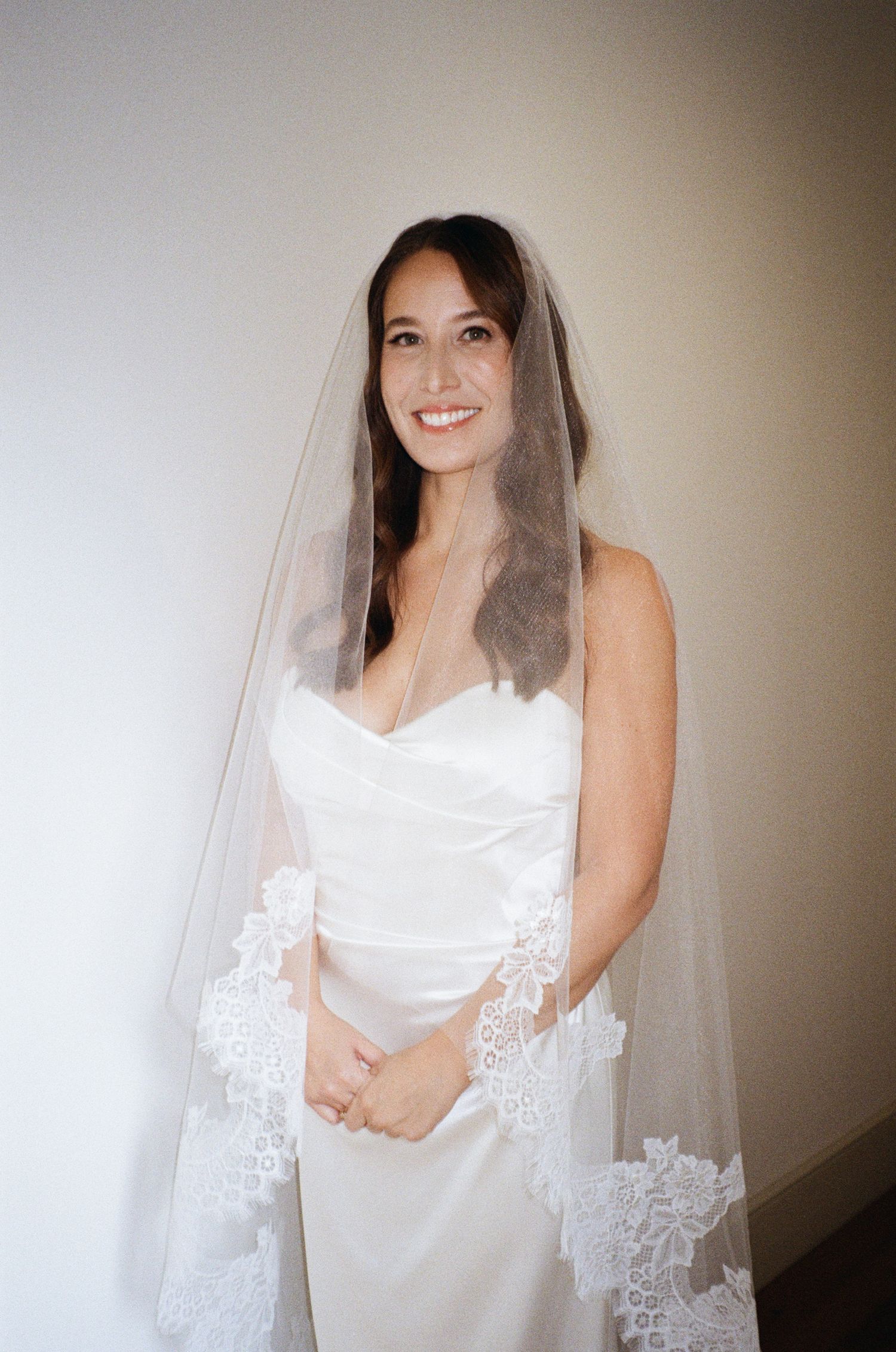A series of bridal portraits showing a woman in a white wedding dress and veil against a light background.