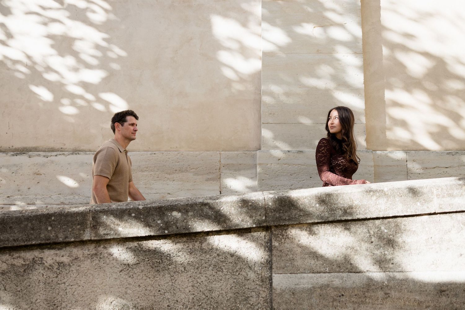 A minimalist black and white photo series showing people sitting on steps in dappled sunlight.