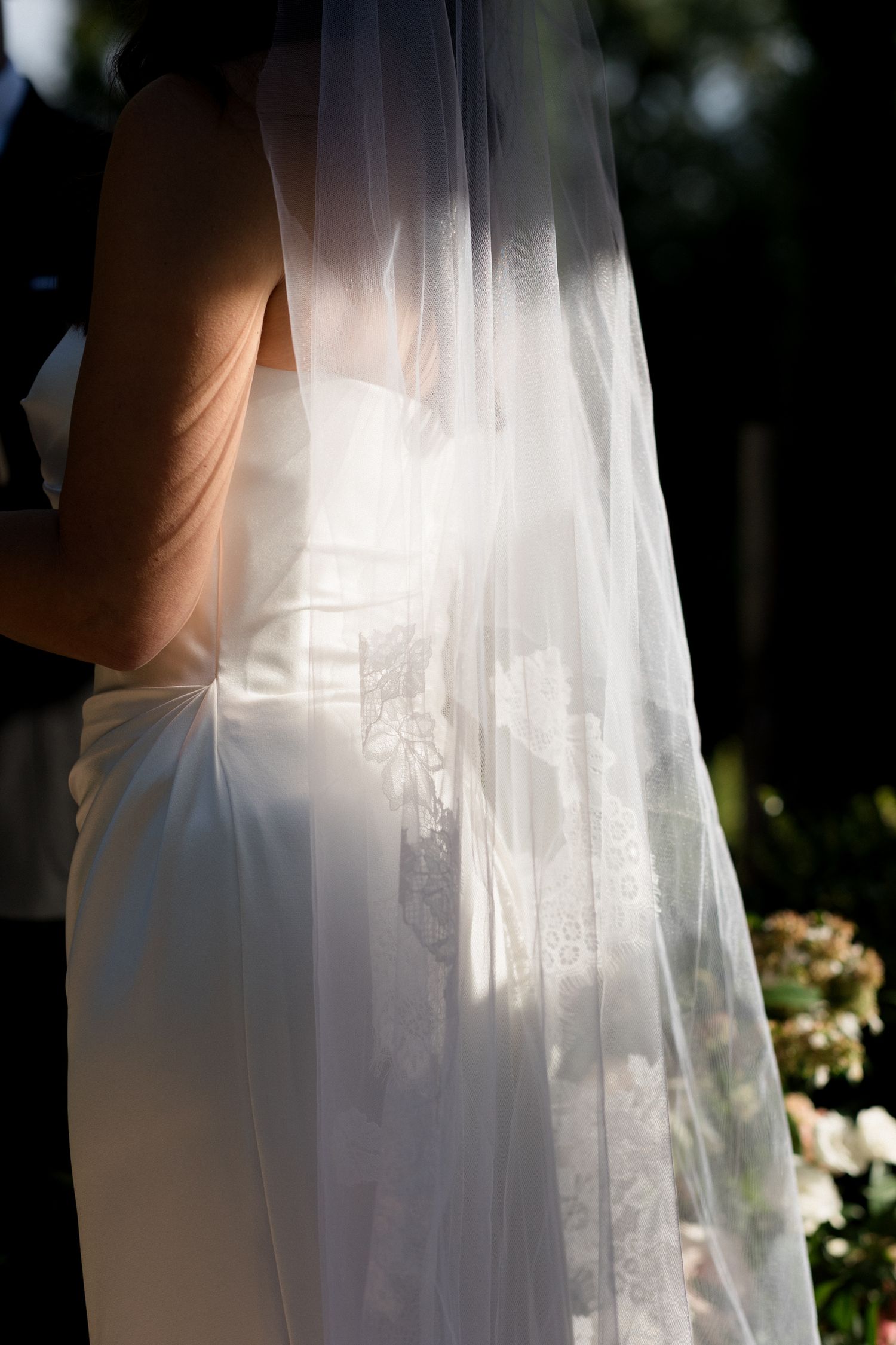 Ethereal white wedding veil flowing in soft sunlight against a natural outdoor backdrop. wedding photographer france