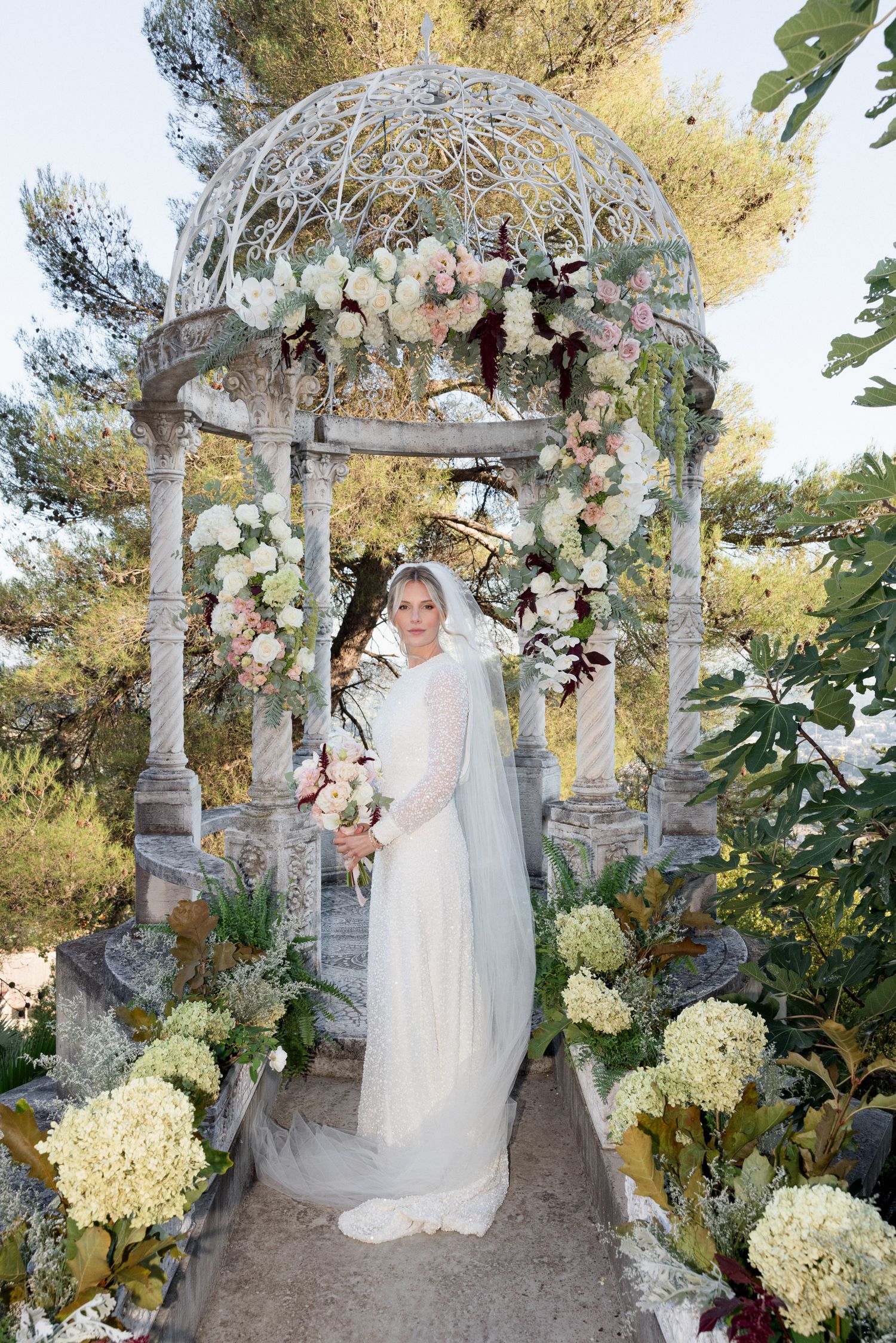 Elegant wedding ceremony setup with floral-adorned gazebo and white hydrangeas in a garden setting. Intimate wedding french riviera