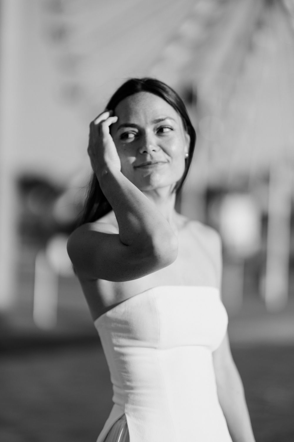 Person in white top posing expressively at outdoor location. Seance couple Tours