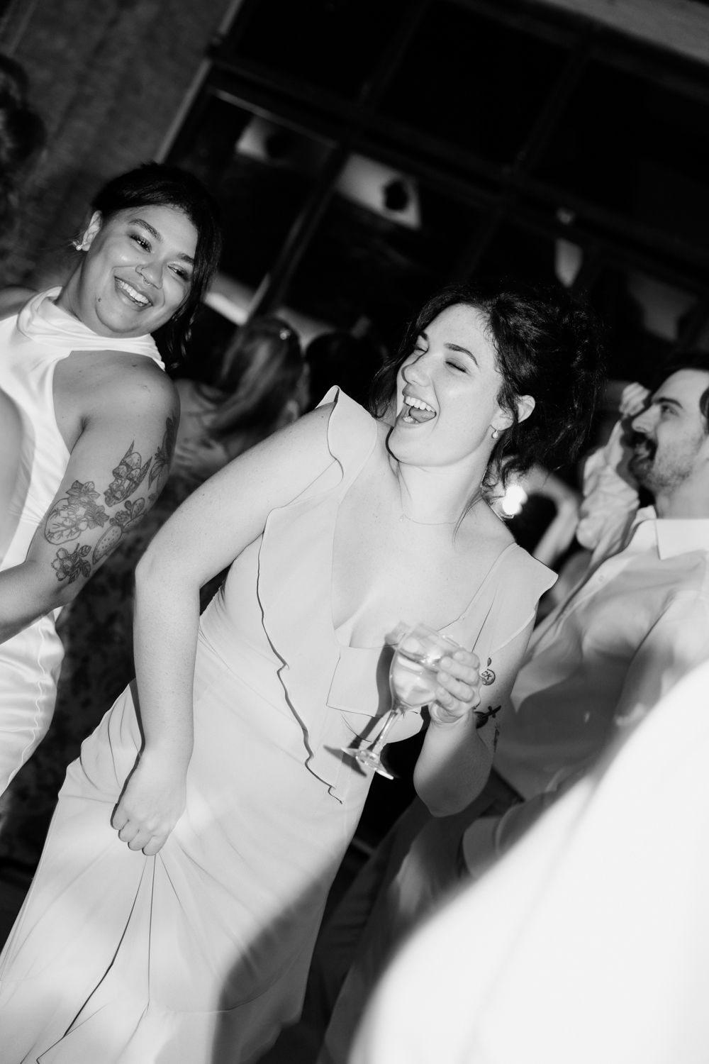 A series of black and white party photos show people laughing and enjoying drinks at a social gathering.