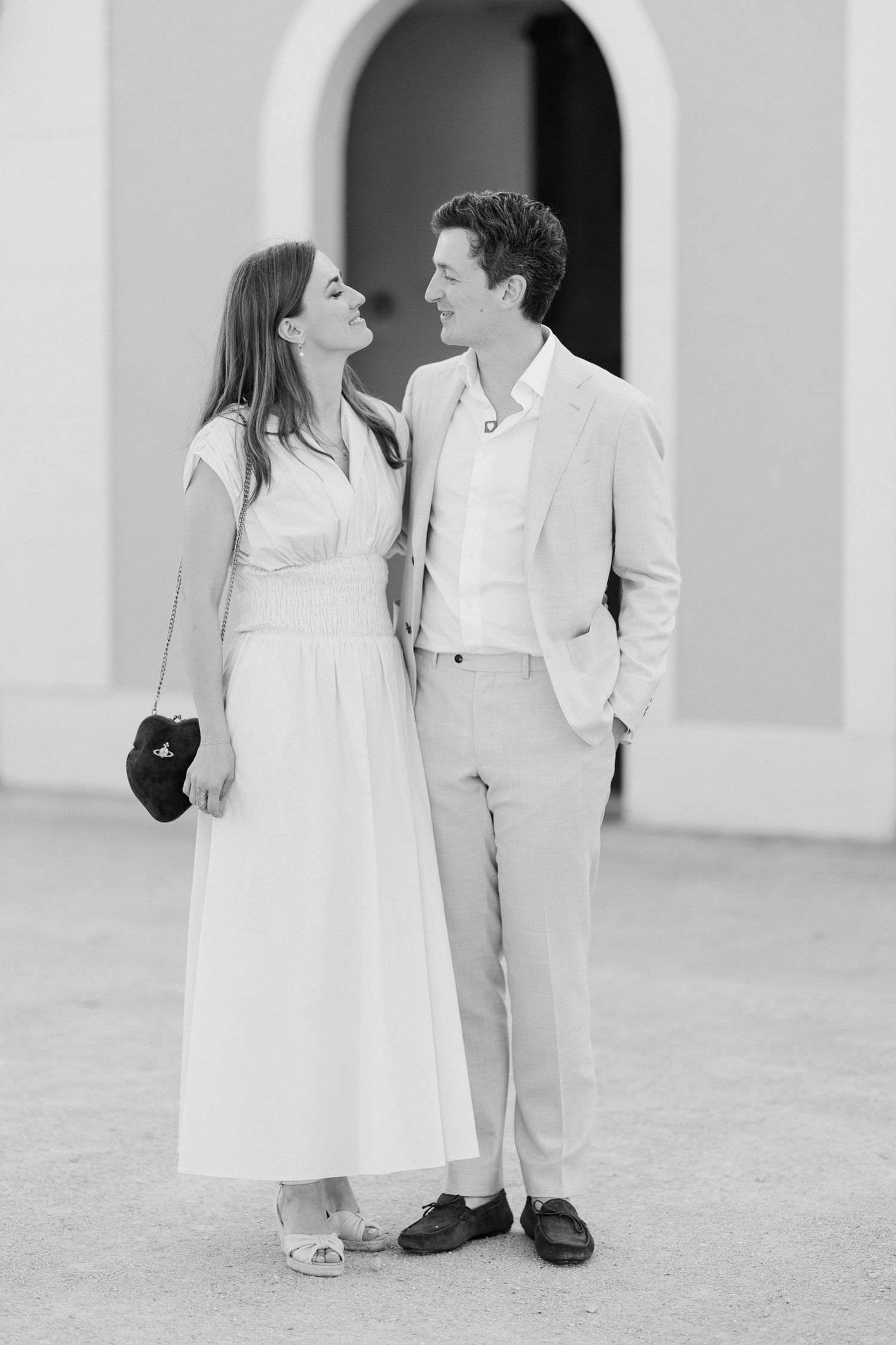 Two young children in white outfits share sweet moments together in a series of black and white photographs. Loire valley wedding photograph