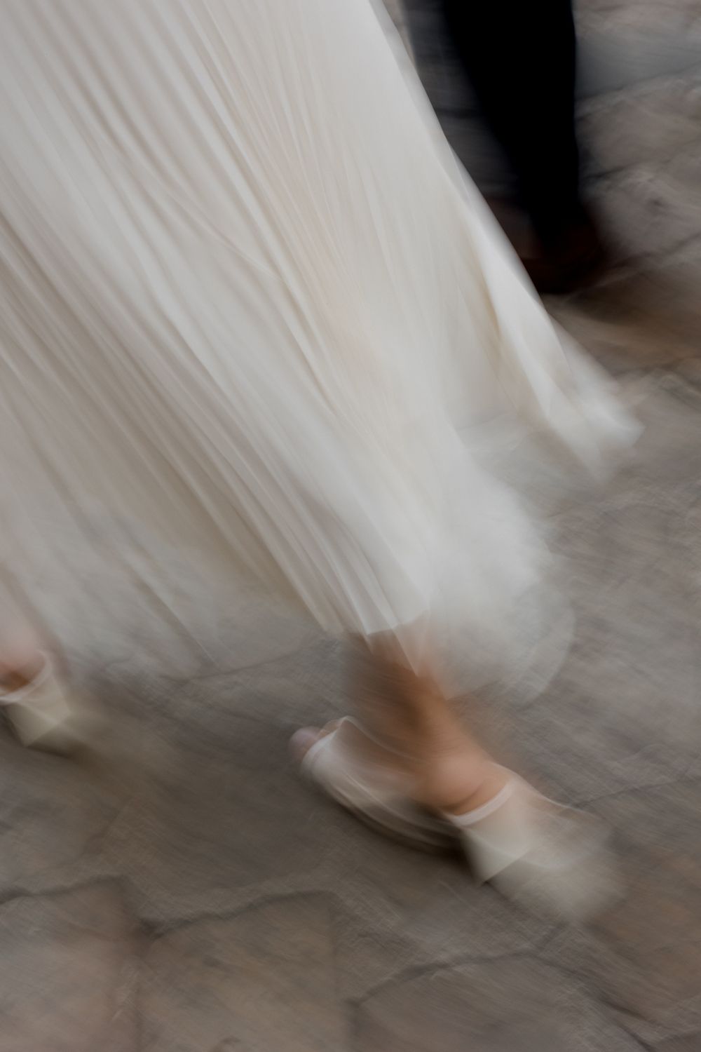 Abstract motion blur of flowing white fabric creating ethereal movement patterns.
