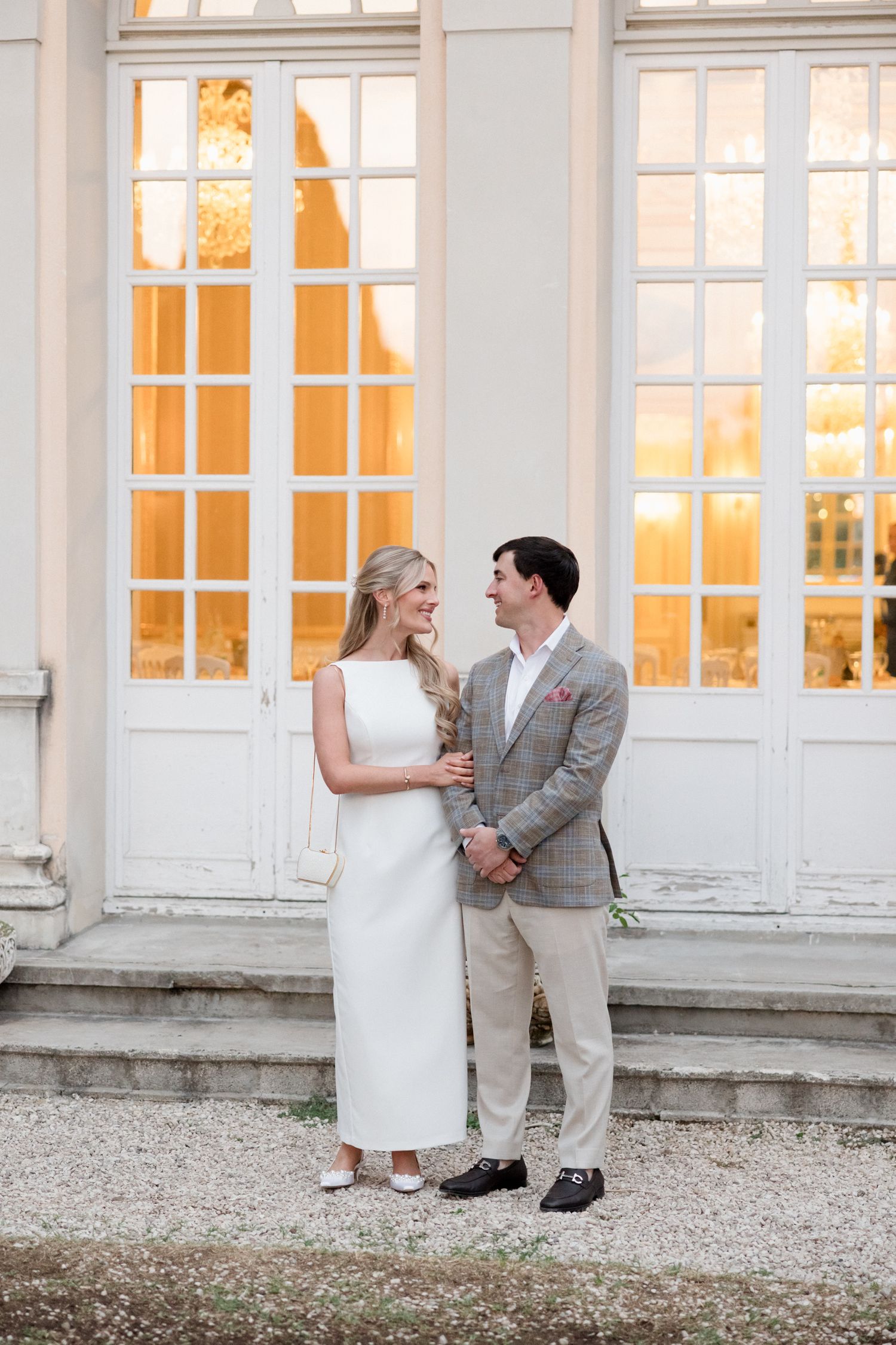 Four sequential photos showing a romantic moment between a couple in formal attire against a white building exterior.