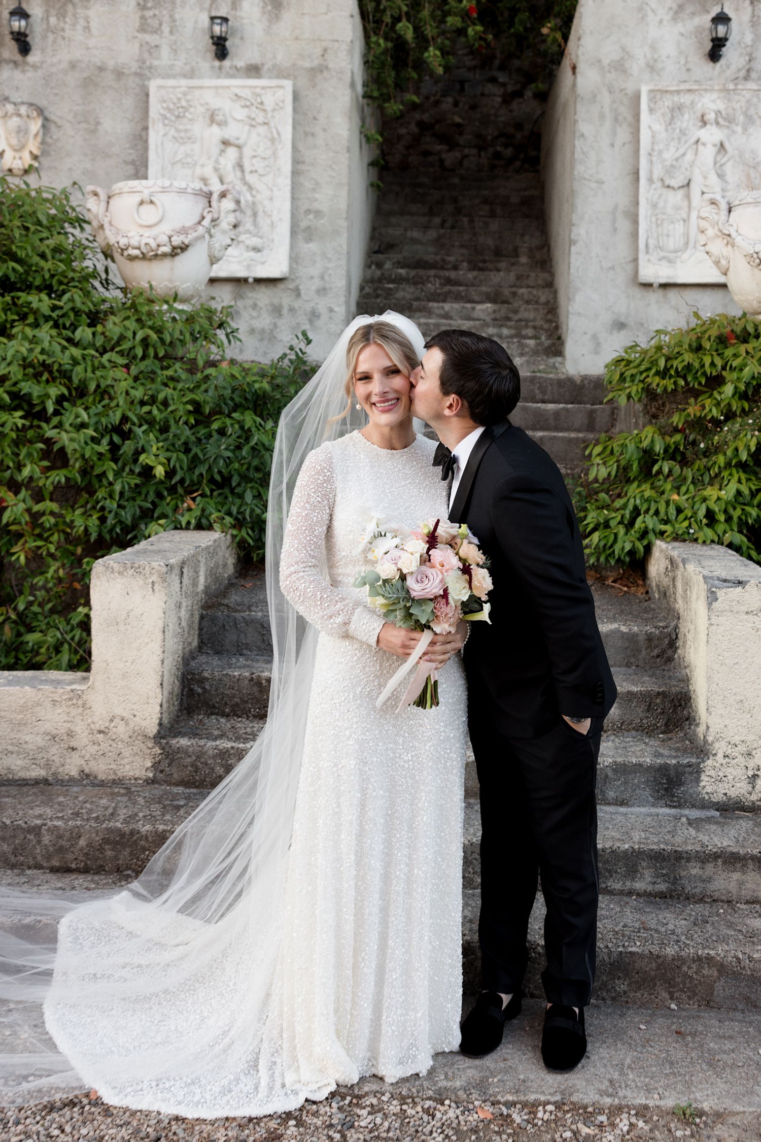 A romantic wedding moment captured in a series of photos showing a couple against a stone wall with decorative plaques.