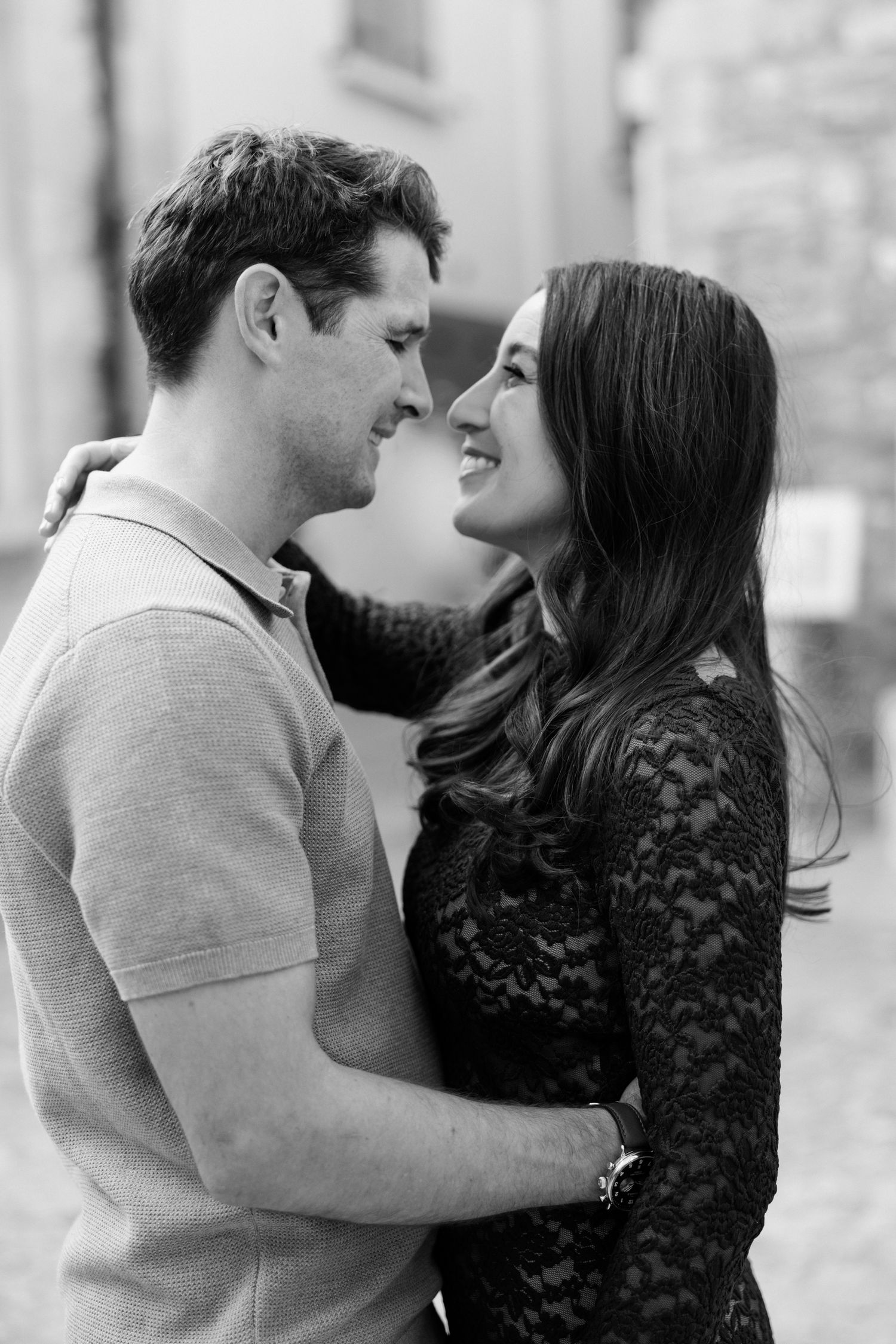 Romantic black and white photo of a couple in an intimate embrace sharing a tender moment.